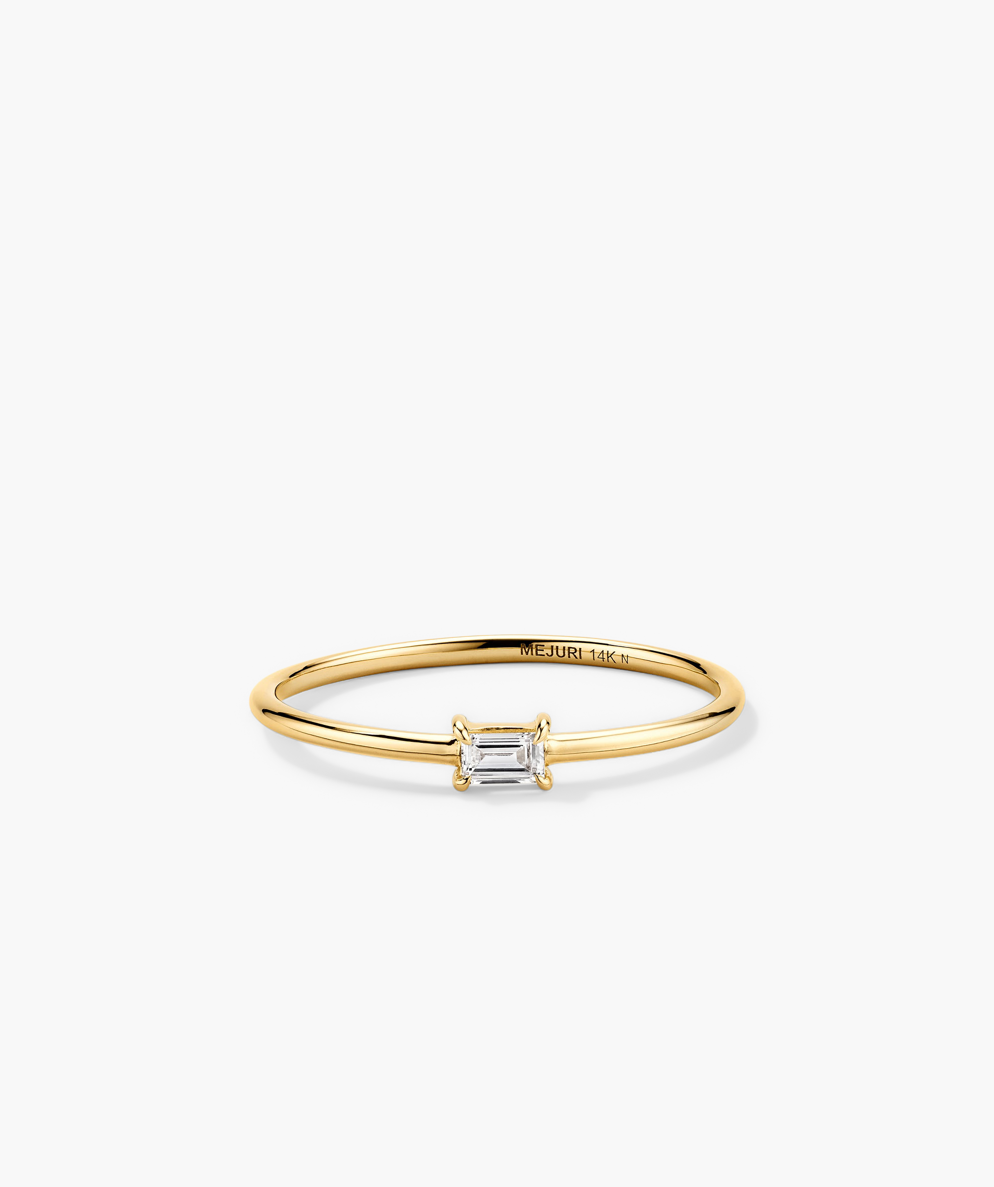 Baguette Stacker Ring: A gold ring featuring a prominent diamond baguette stone, perfect as an elegant fashion accessory or engagement ring.