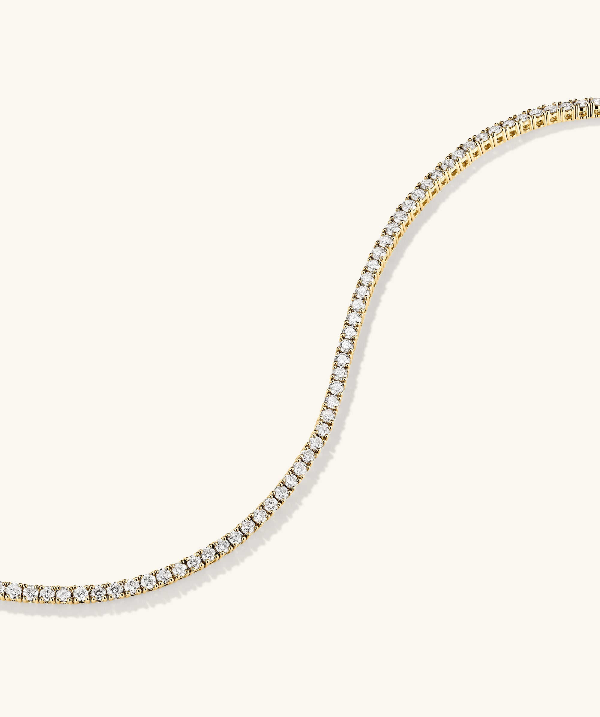 Diamond Tennis Bracelet 1.8mm: A delicate 14k gold bracelet adorned with small, sparkling diamonds, featuring a secure clasp with safety arms for easy wear.