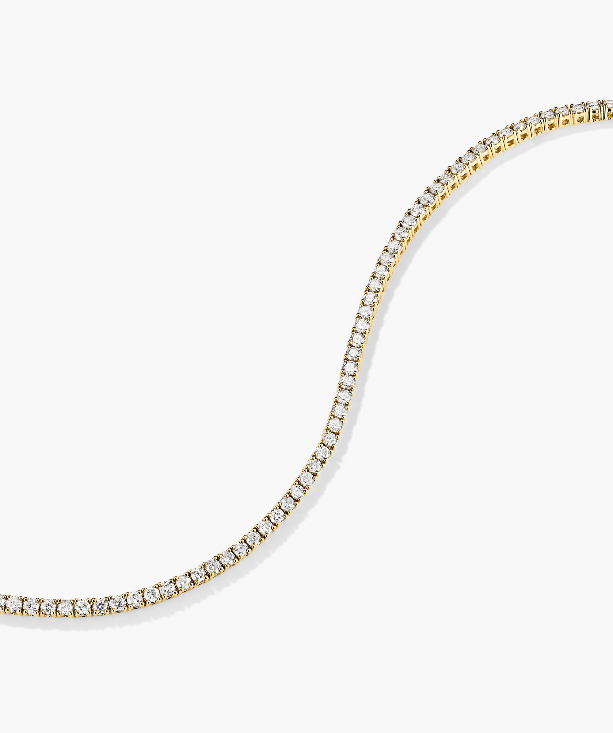 Diamond Tennis Bracelet 1.8mm: A delicate 14k gold bracelet adorned with small, sparkling diamonds, featuring a secure clasp with safety arms for easy wear.