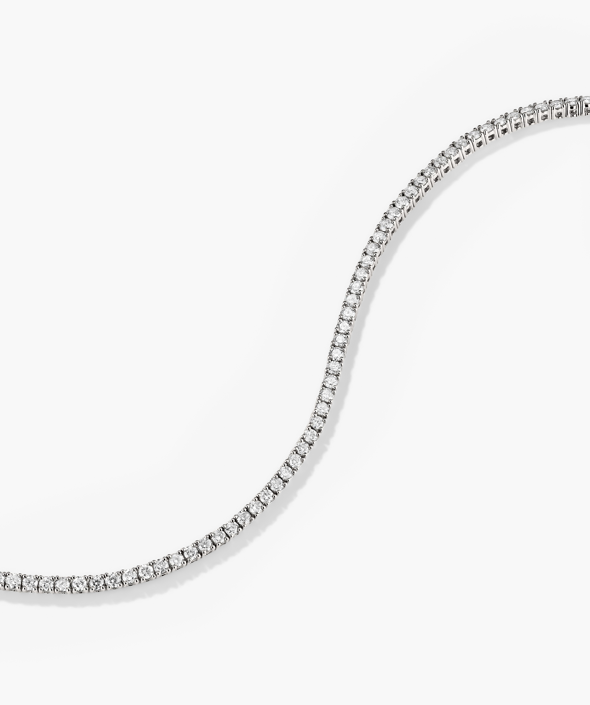 Diamond Tennis Bracelet 1.8mm featuring a close-up of a 14k solid gold bracelet adorned with responsibly sourced diamonds, showcasing its intricate design and secure clasp mechanism.