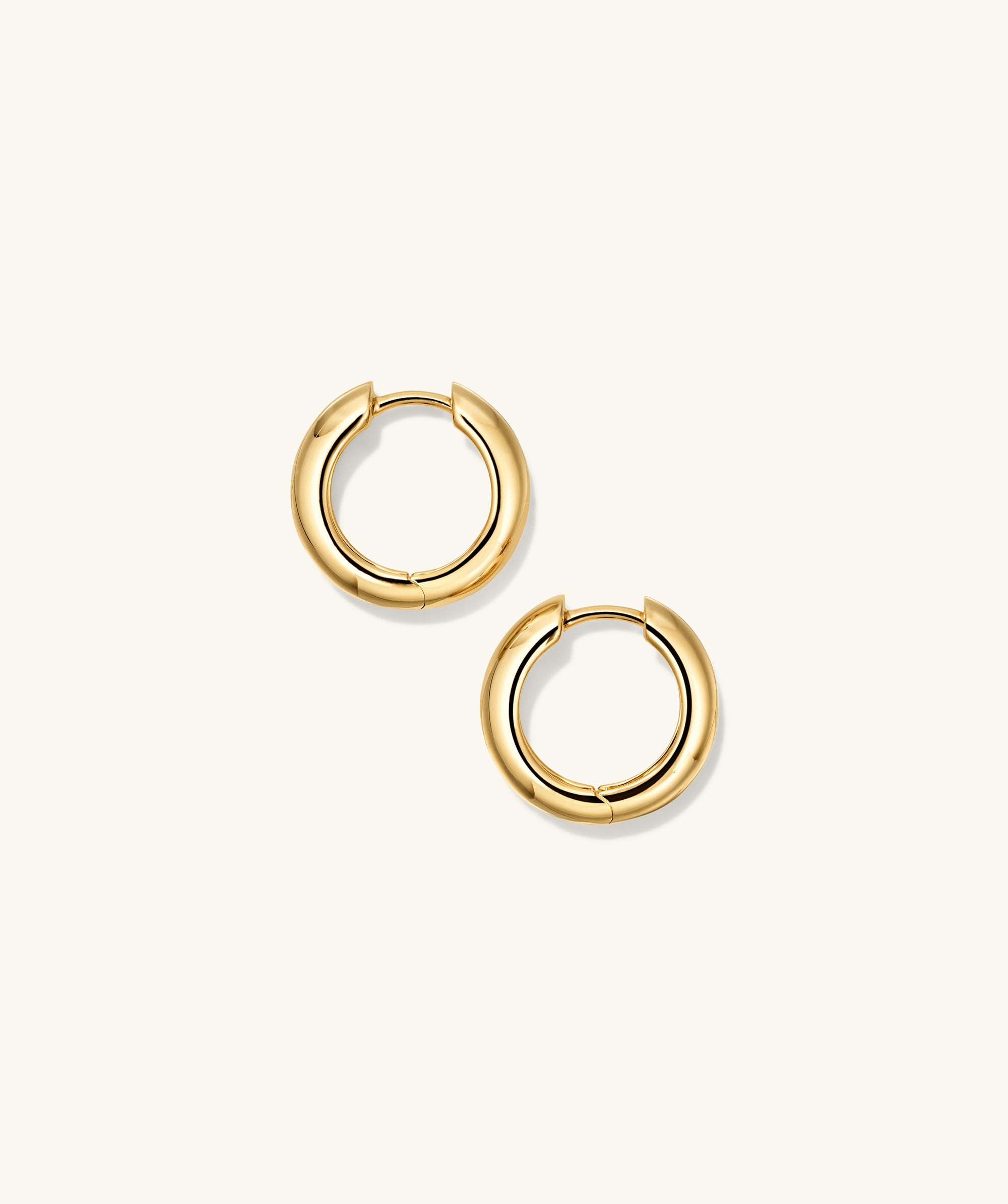 Plush Small Hoops: a pair of handcrafted 14k gold hoop earrings with a pillowy design.