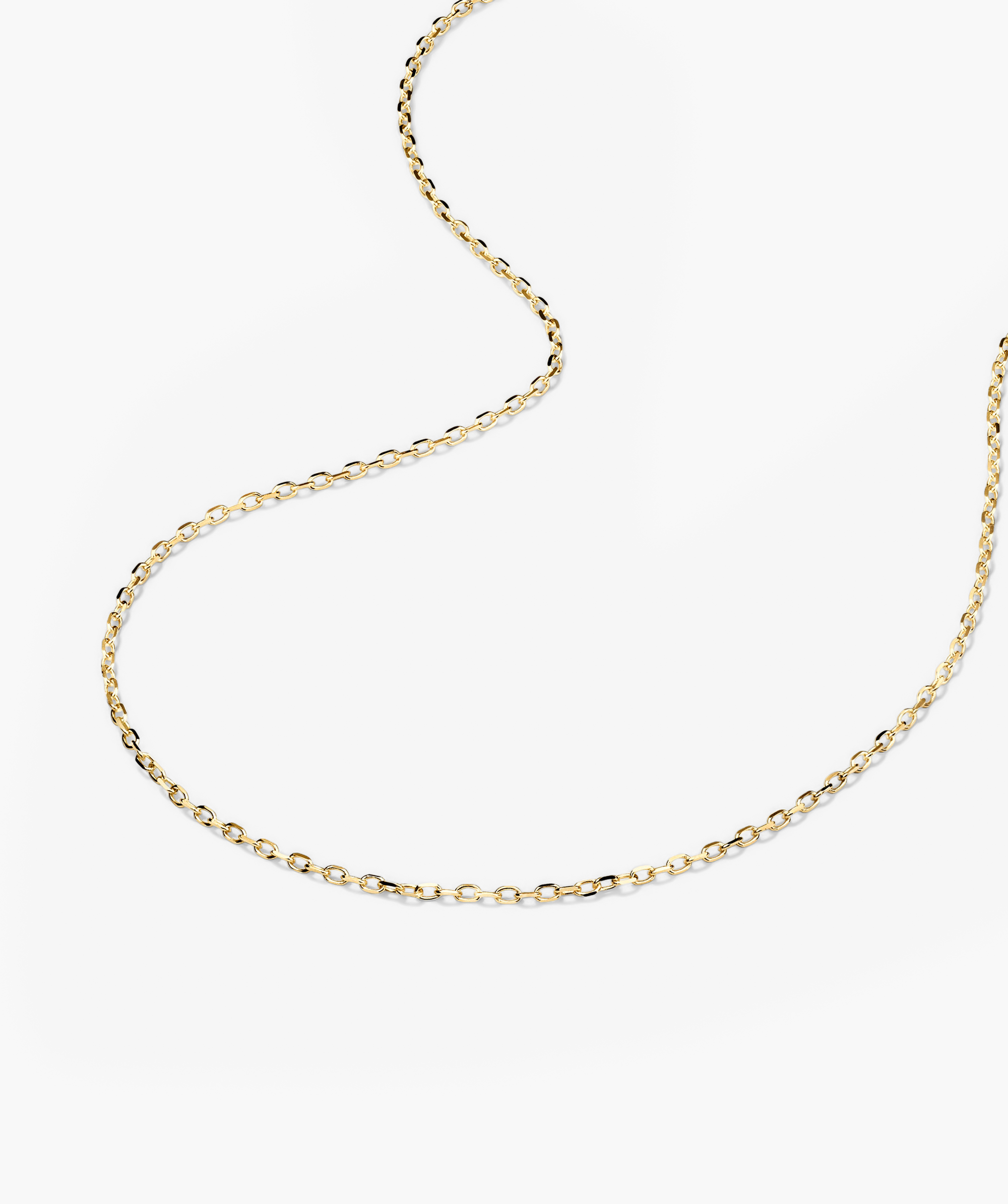 Gold Chain Necklace on a white surface, ideal for adding charms or layering with other necklaces and chokers.