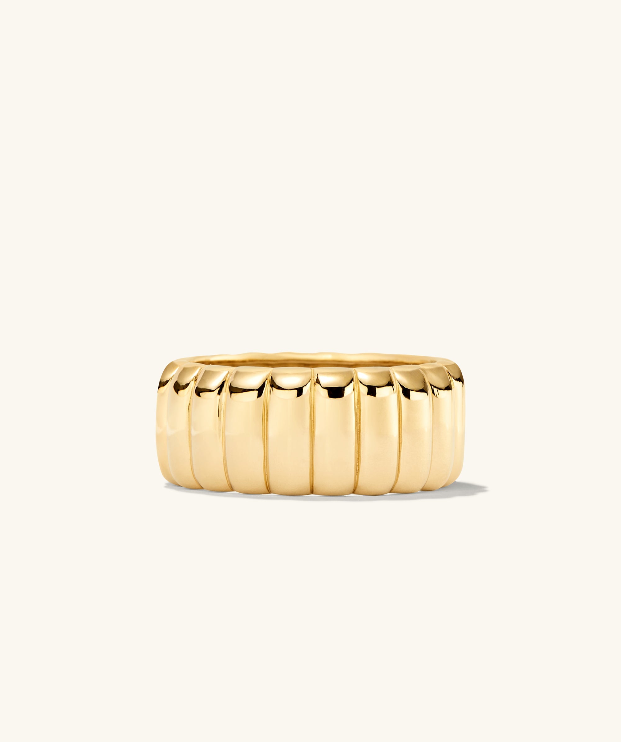 Gold ring named Charlotte Bold Ring, inspired by French dessert, with intricate design details, displayed on a white background.