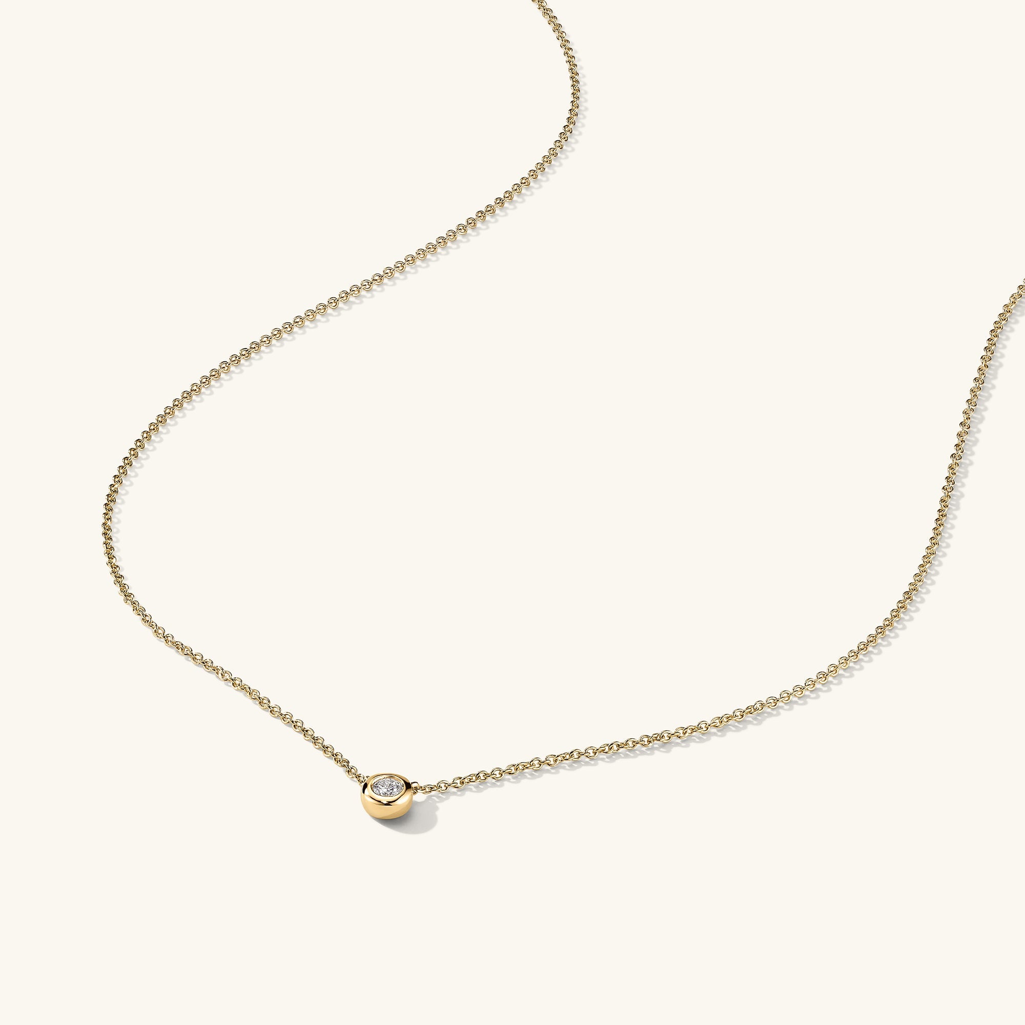 Diamond Necklace: A 14k solid gold necklace featuring a round cut, responsibly sourced diamond in a bezel setting. Classic and timeless piece.