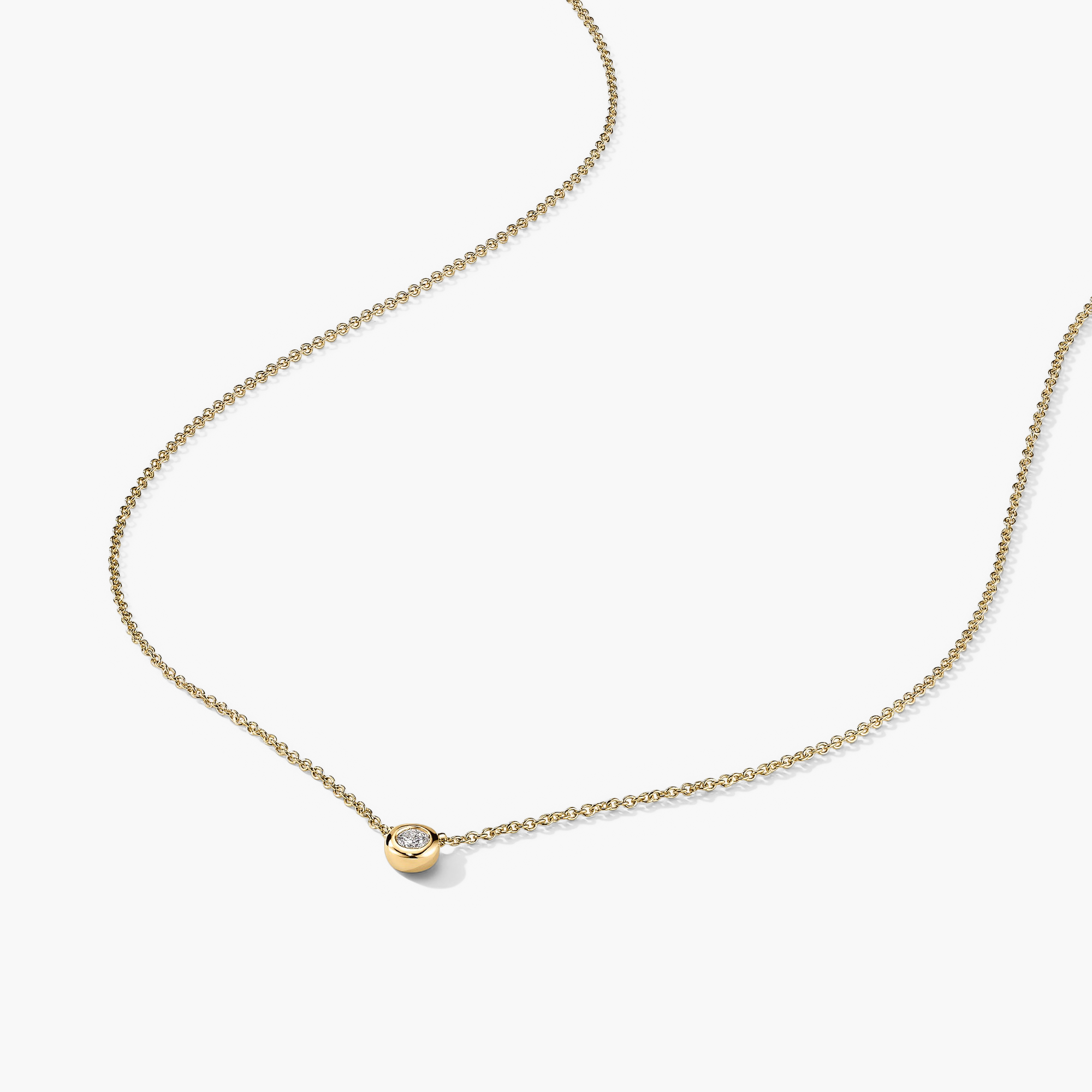 Diamond Necklace: A 14k solid gold necklace featuring a round cut, responsibly sourced diamond in a bezel setting. Classic and timeless piece.
