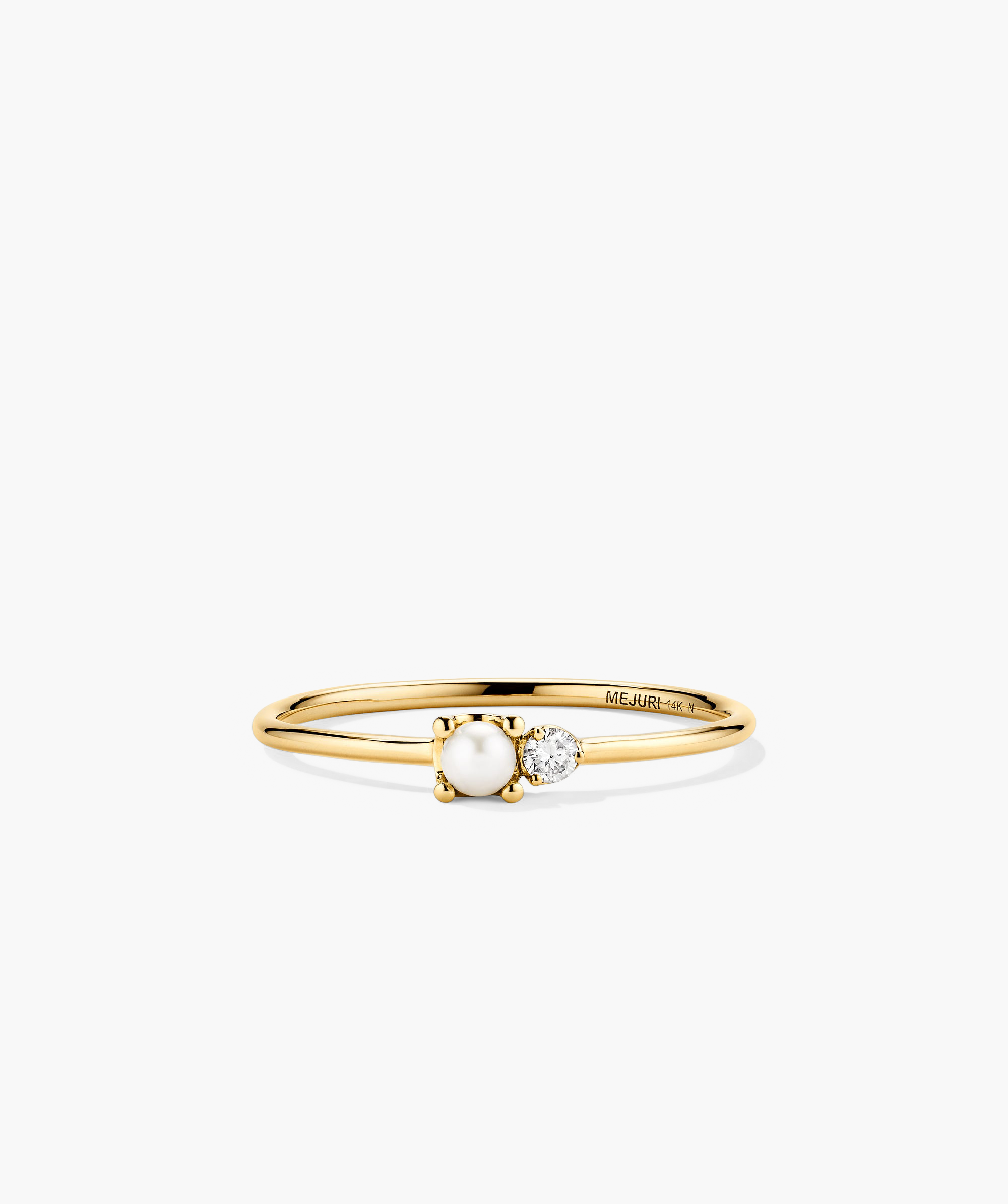 Pearl and Diamond Stacker Ring: A close-up of a 14k gold ring featuring a central freshwater pearl and two side diamonds.