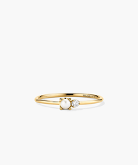 Pearl and Diamond Stacker Ring: A close-up of a 14k gold ring featuring a central freshwater pearl and two side diamonds.