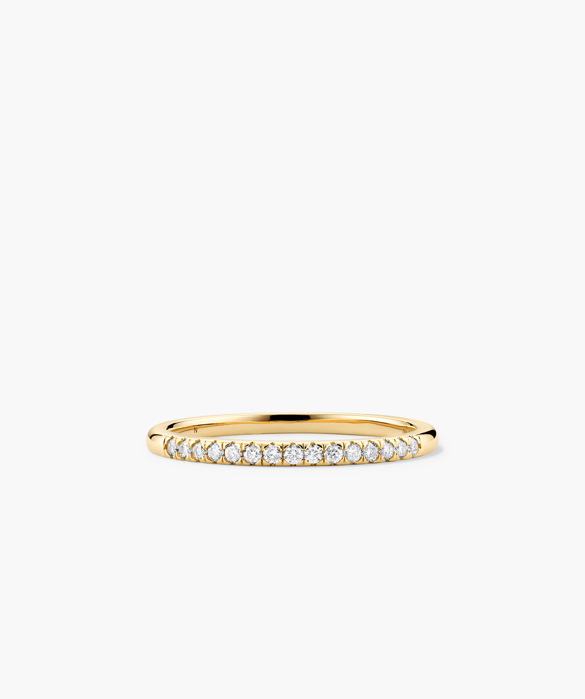 Gold ring with diamonds, named Diamonds Team Ring, shown in close-up view. Elegant design, perfect for stacking and enhancing any outfit.