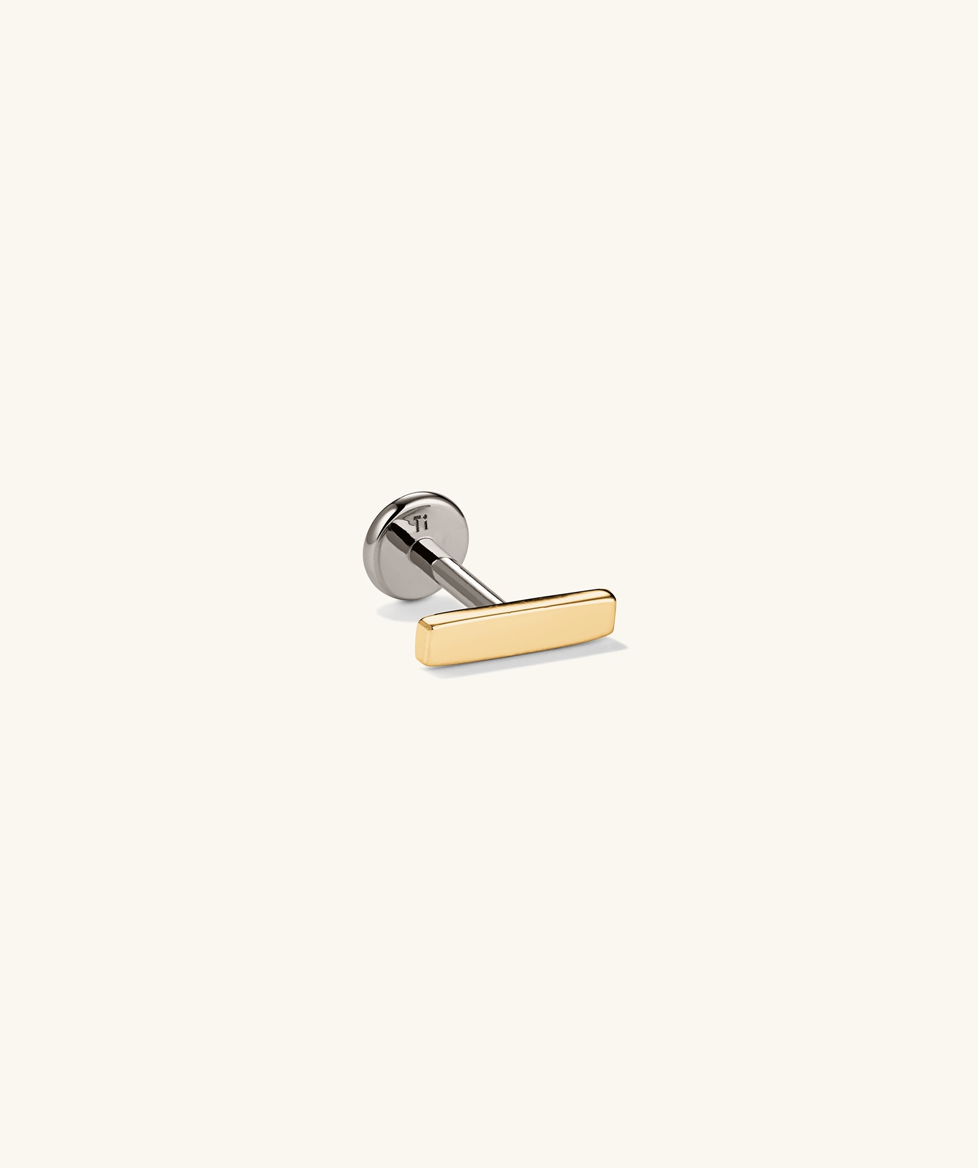Close-up of Piercing Studio - Bar Flat Back Stud, showcasing its sleek metal design and classic style, perfect for adding elegance to any earring stack.