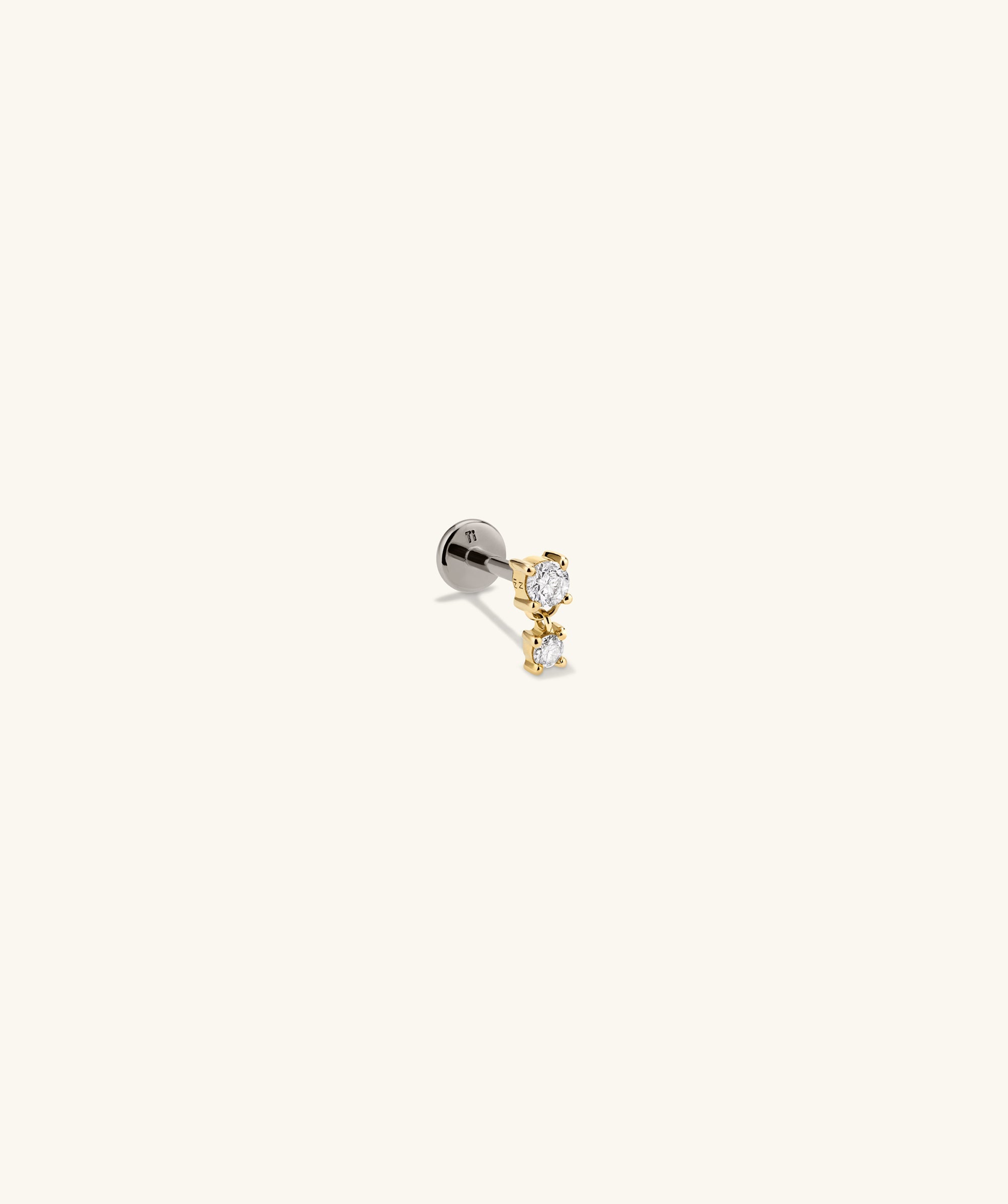 Close-up of the Piercing Studio - Diamond Droplet Stud, showcasing a delicate design with a shimmering diamond accent, perfect for an elegant, modern look.