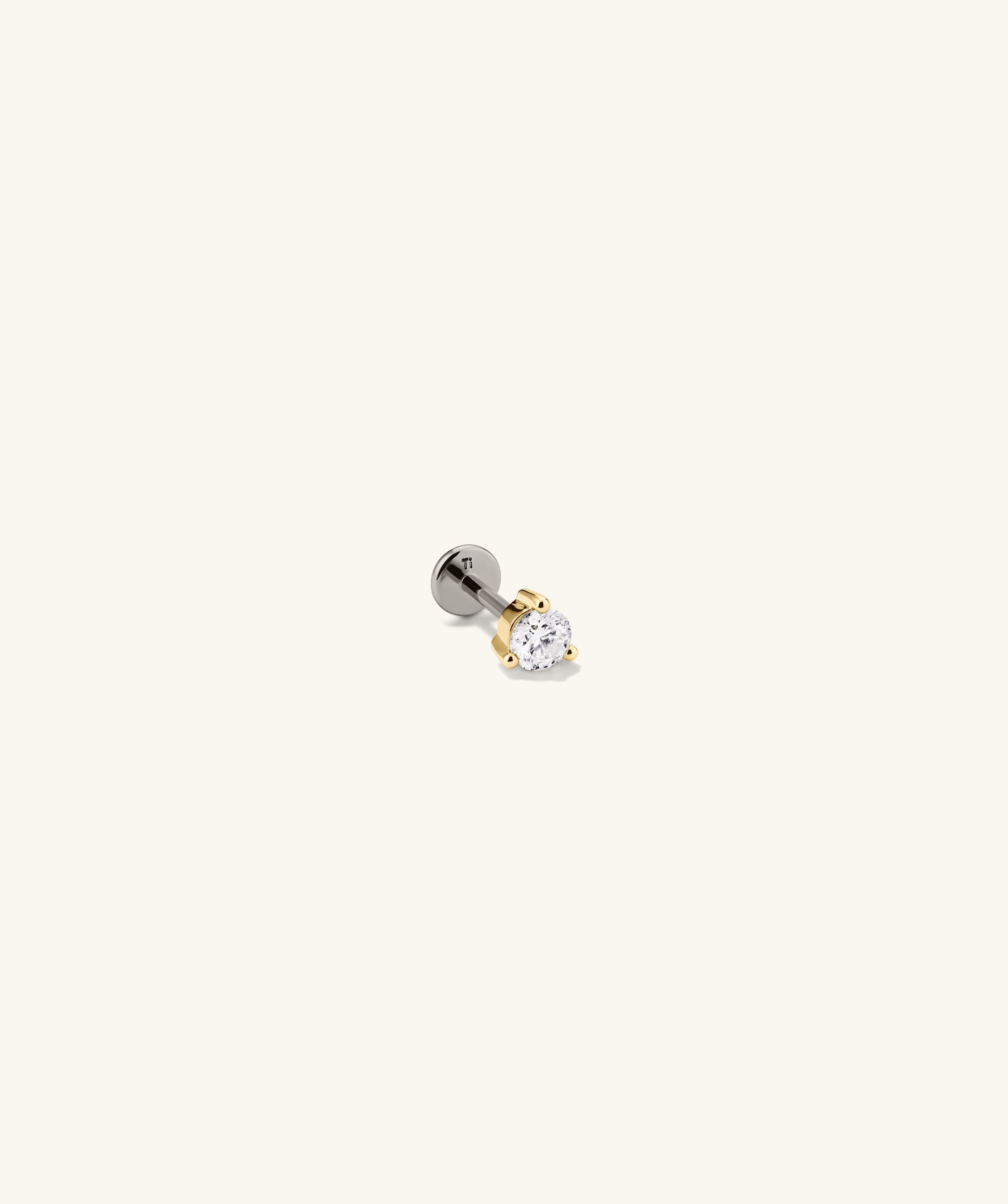 Close-up of the Piercing Studio - Round Diamond Flat Back Stud, showcasing its simple, elegant design ideal for stackable earring collections.