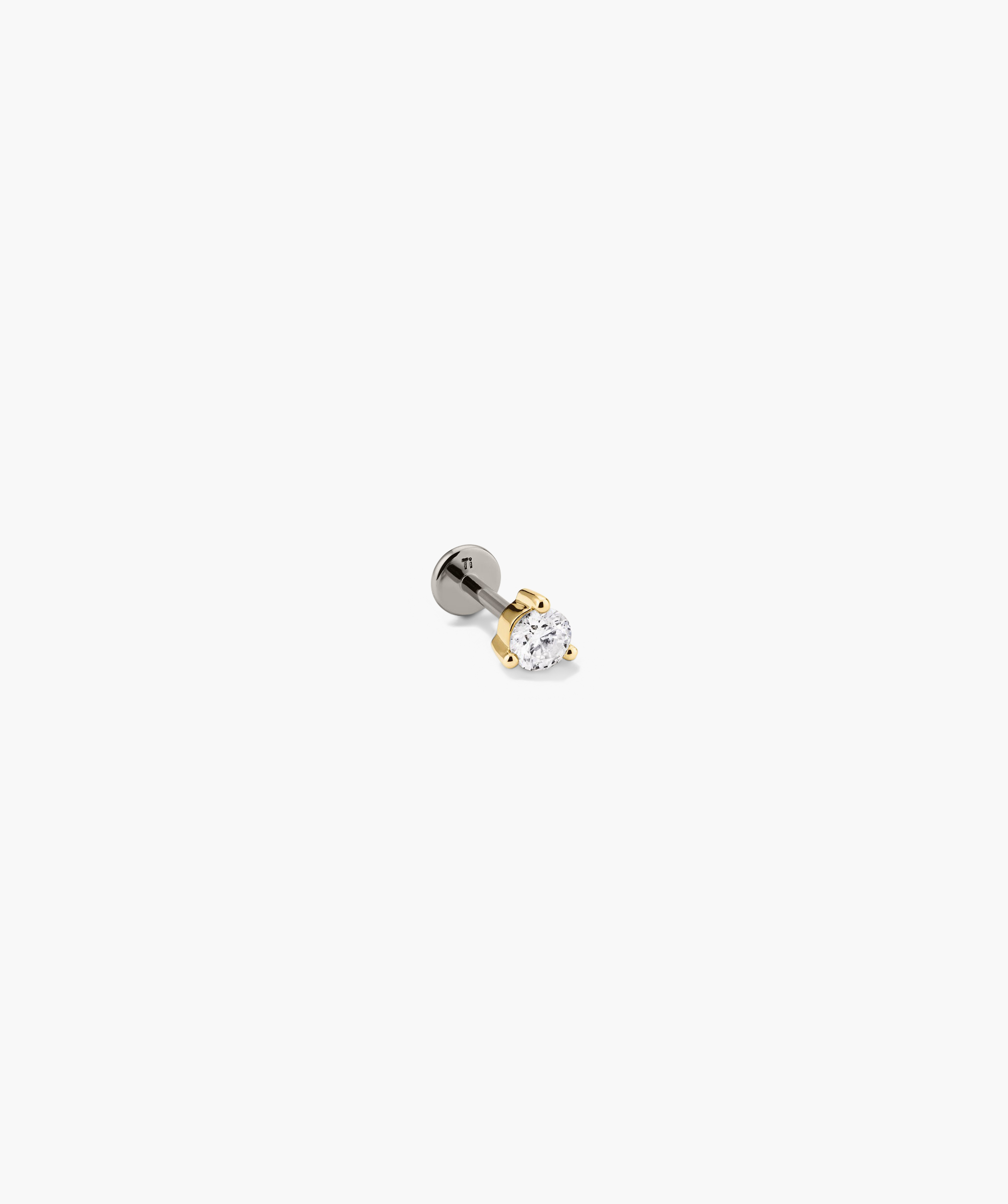Close-up of the Piercing Studio - Round Diamond Flat Back Stud, showcasing its simple, elegant design ideal for stackable earring collections.