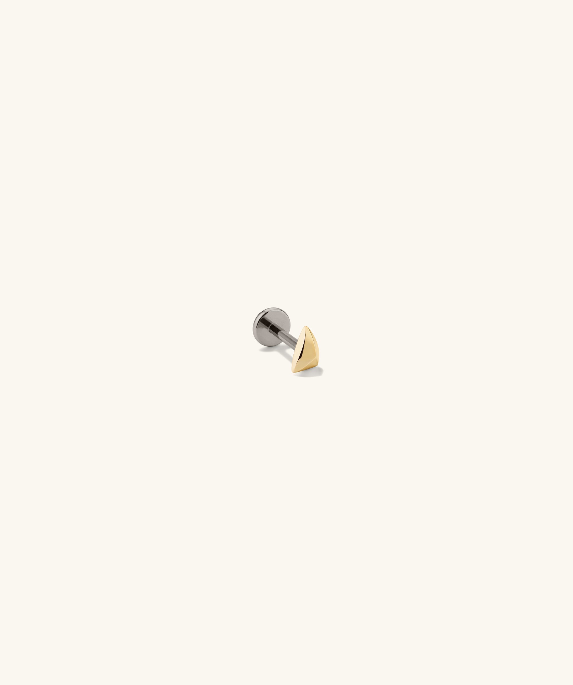 Close-up of the Piercing Studio - Puffy Pyramid Flat Back Stud, showcasing its unique, soft pyramid shape designed for a bold yet comfortable look.