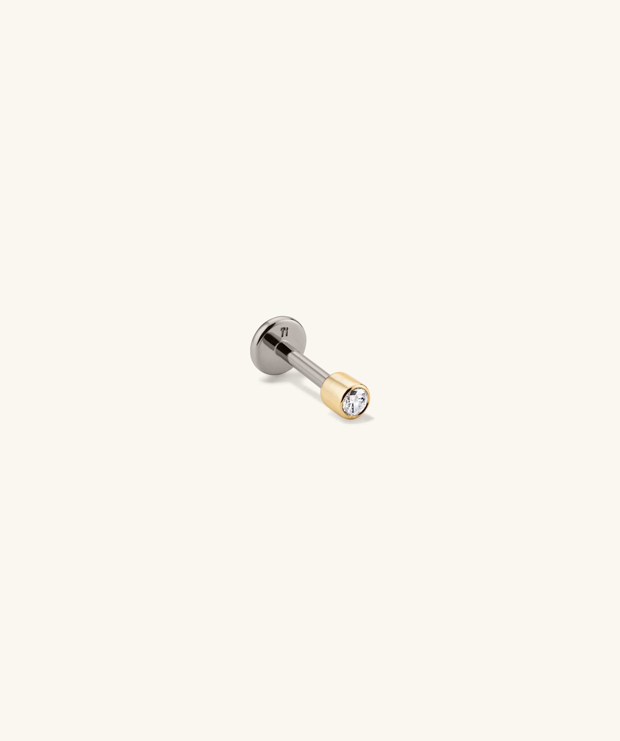 Close-up of the Piercing Studio - Micro Diamond Flat Back Stud, showcasing intricate silver and gold design with a prominent diamond detail, highlighting its elegant impact.