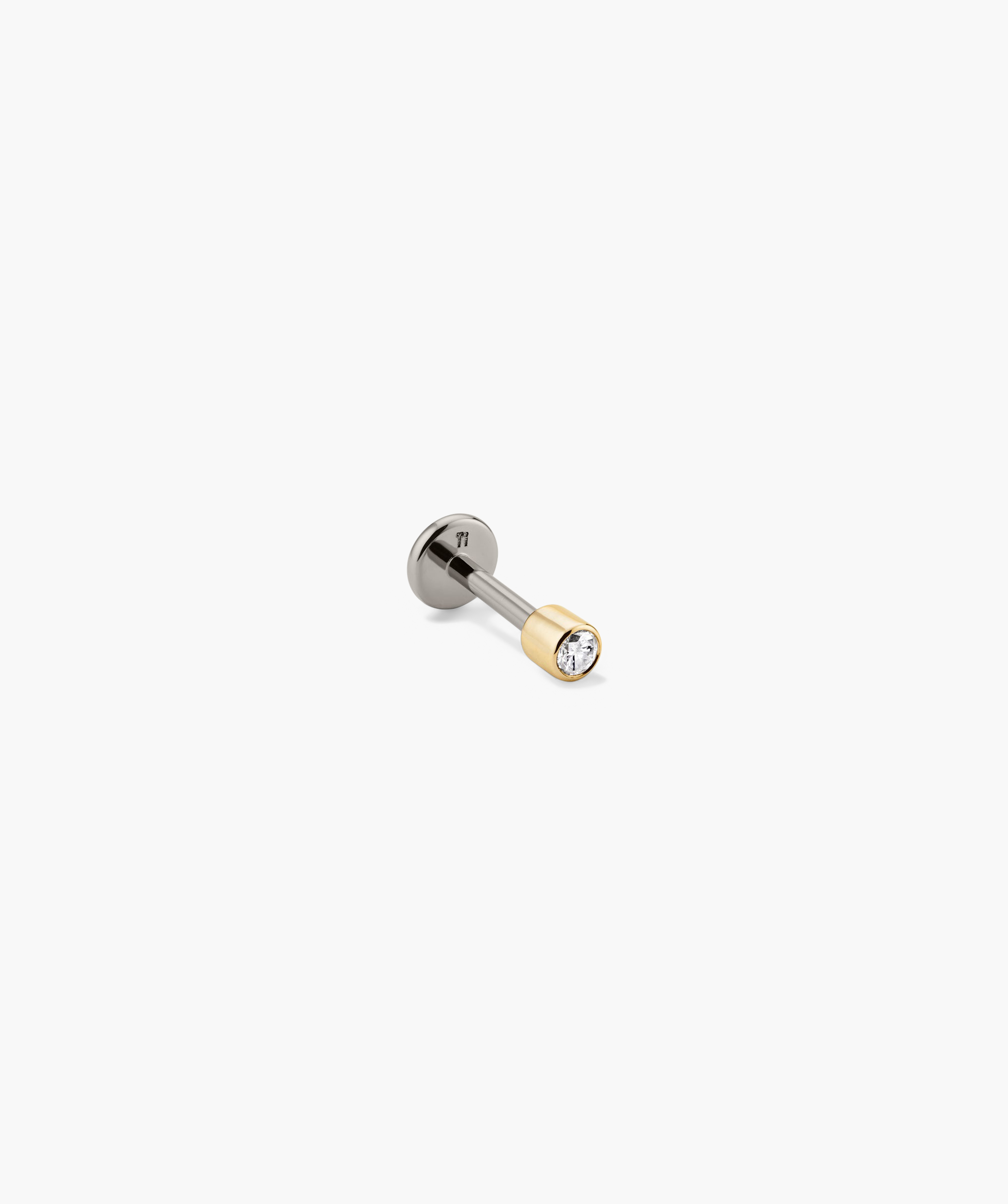 Close-up of the Piercing Studio - Micro Diamond Flat Back Stud, showcasing intricate silver and gold design with a prominent diamond detail, highlighting its elegant impact.