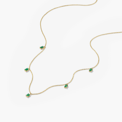 Baguette Gemstone Station Necklace featuring a gold chain adorned with green stones, perfect for creating standout jewelry stacks.