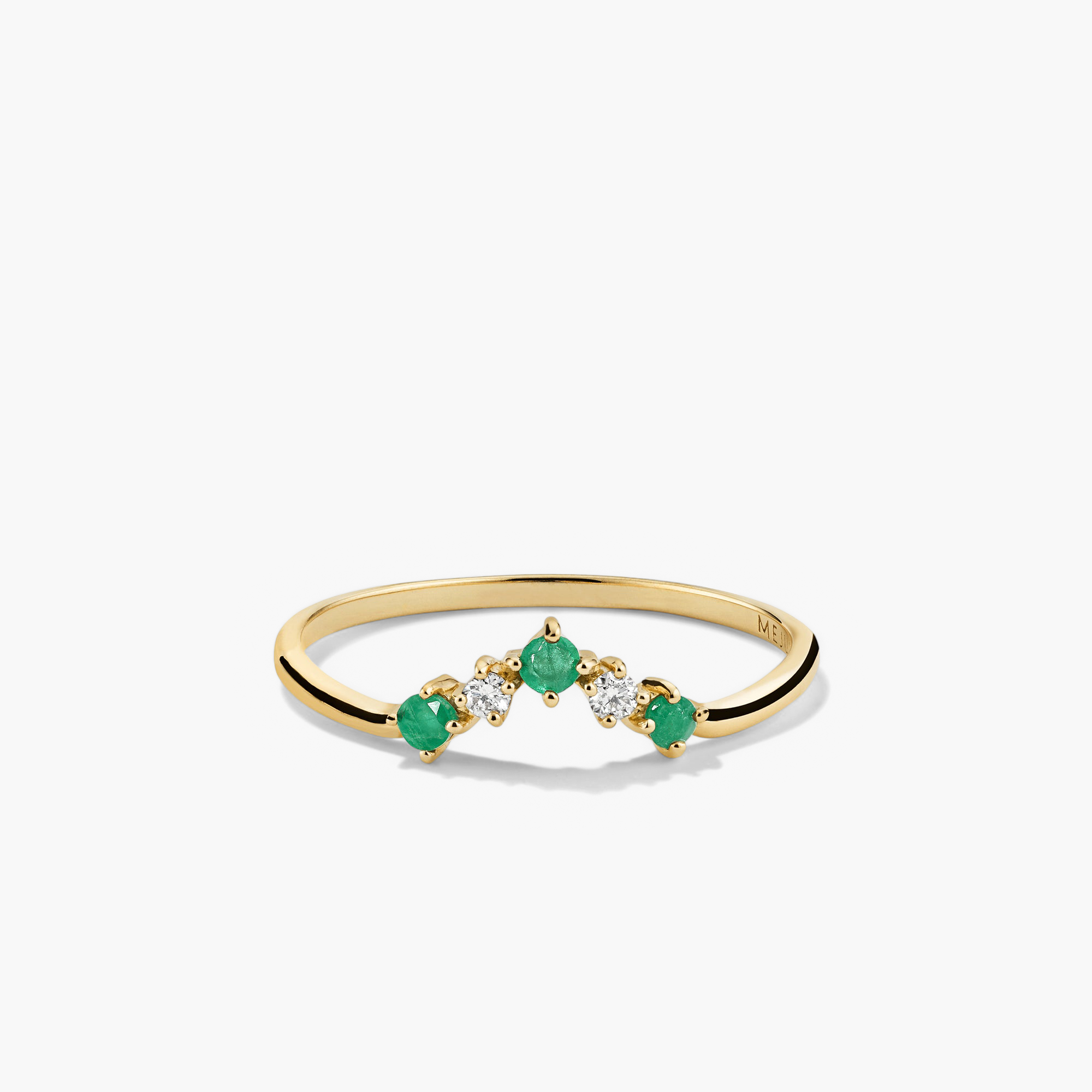 Emerald and Diamond Wishbone Ring: 14k gold ring with three stones, featuring emerald gemstones and responsibly sourced diamonds, showcased in a close-up view.