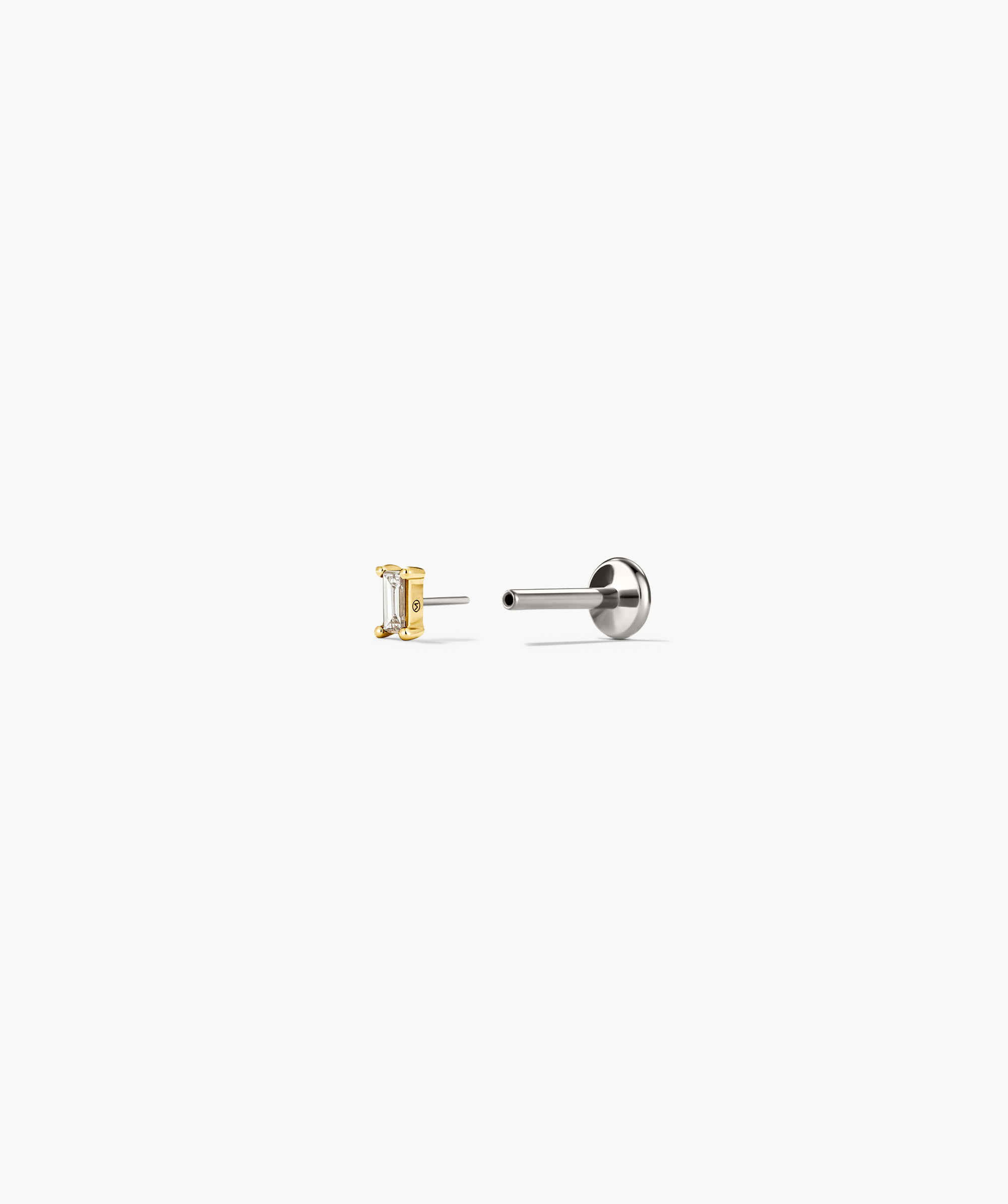 Mini Baguette Stud earring featuring a close-up of a baguette-cut diamond, designed to lie flat against the ear for comfort.