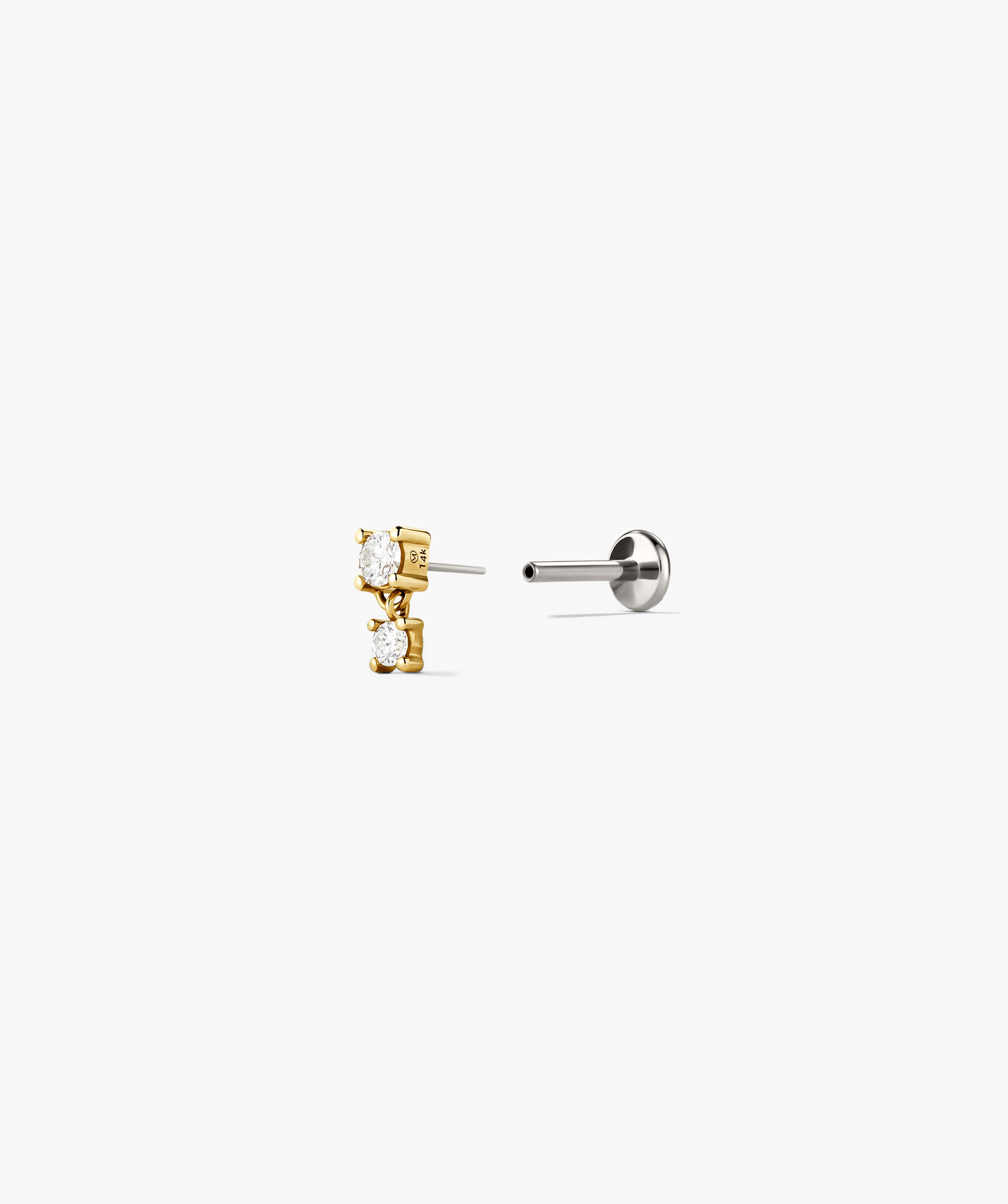 Close-up of the Droplet Stud earring, featuring a diamond stud with a dangling charm, resembling a water droplet. Designed for comfort with flat back studs.