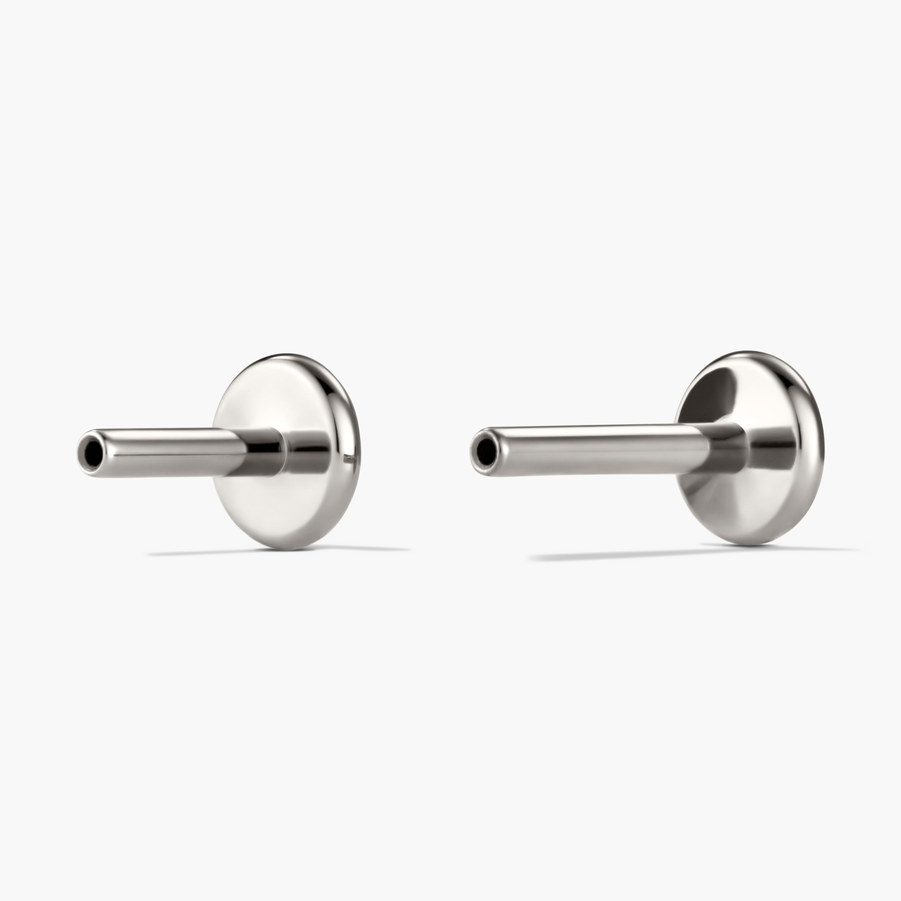 Diamond Mini Stud earrings in a prong setting, featuring miniature diamonds; designed for stacking, with flat backs for comfort and two post sizes for a perfect fit.