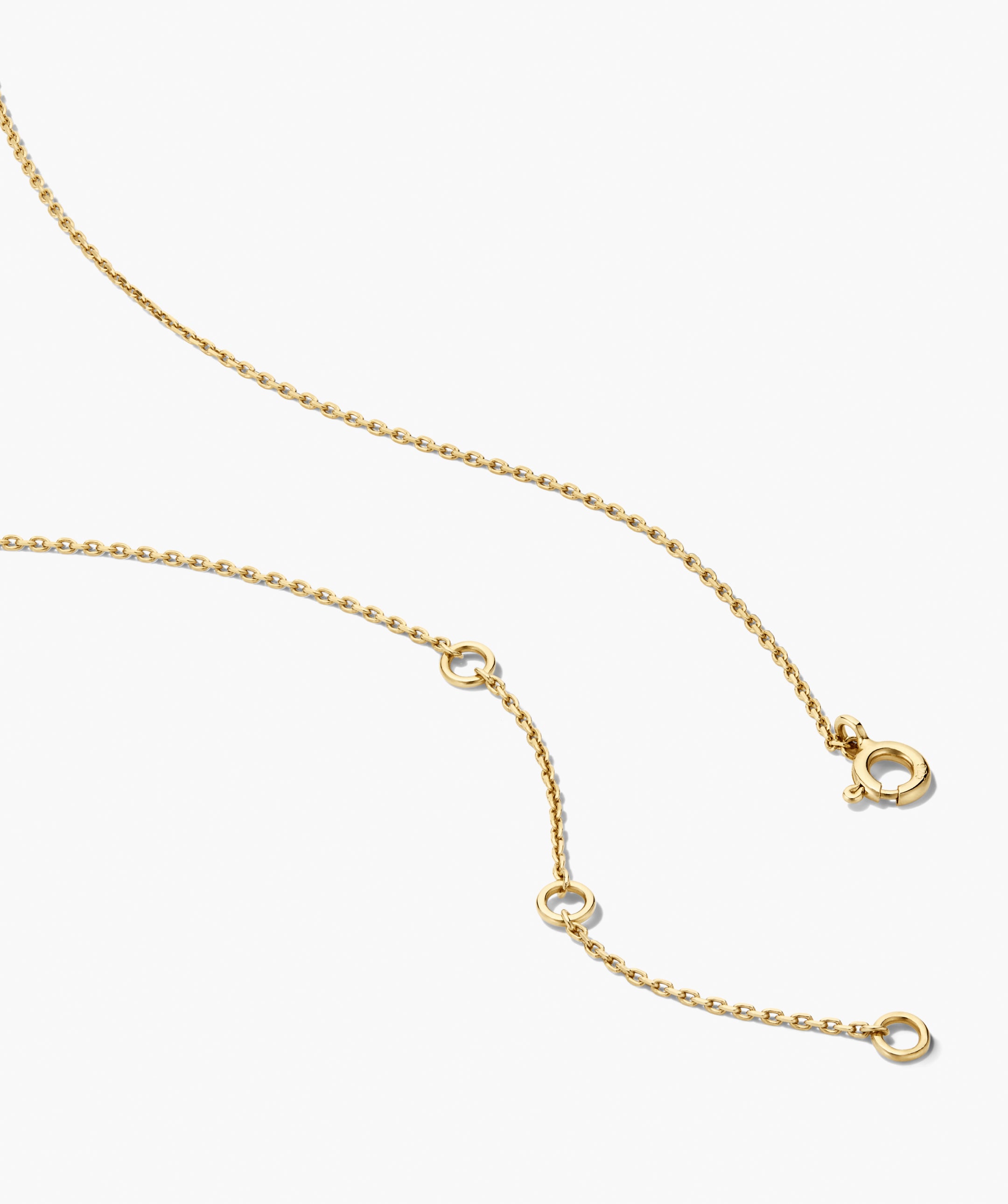 Two of Hearts Necklace featuring a fine yellow-gold chain with adjustable loops, showcasing a unique half-bezel, half-prong sapphire heart pendant.