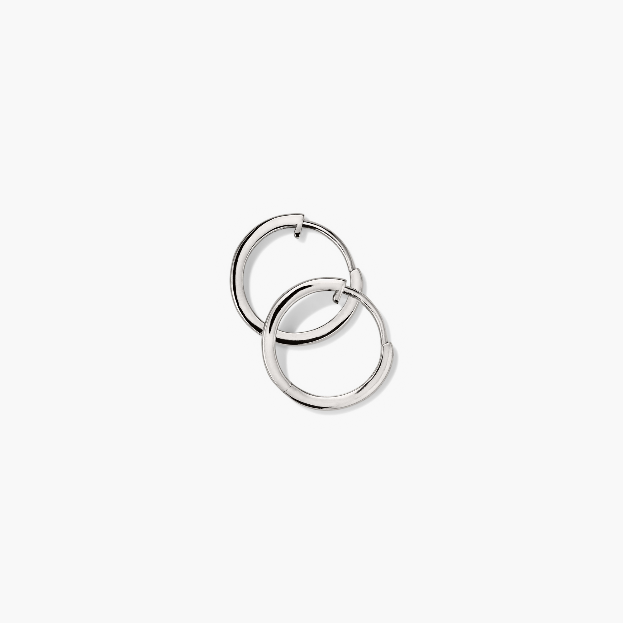 Easy Huggie Hoops: A pair of handcrafted, hollowed 14k gold silver hoop earrings with a secure clicker closure, designed for daily wear.