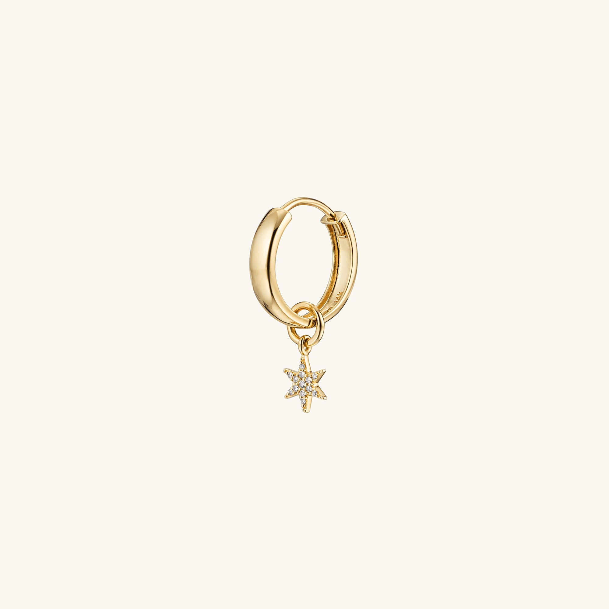 Gold hoop earring with a single pavÃ© diamond star charm, perfect for personalizing your eardrobe with a high-impact, versatile look.