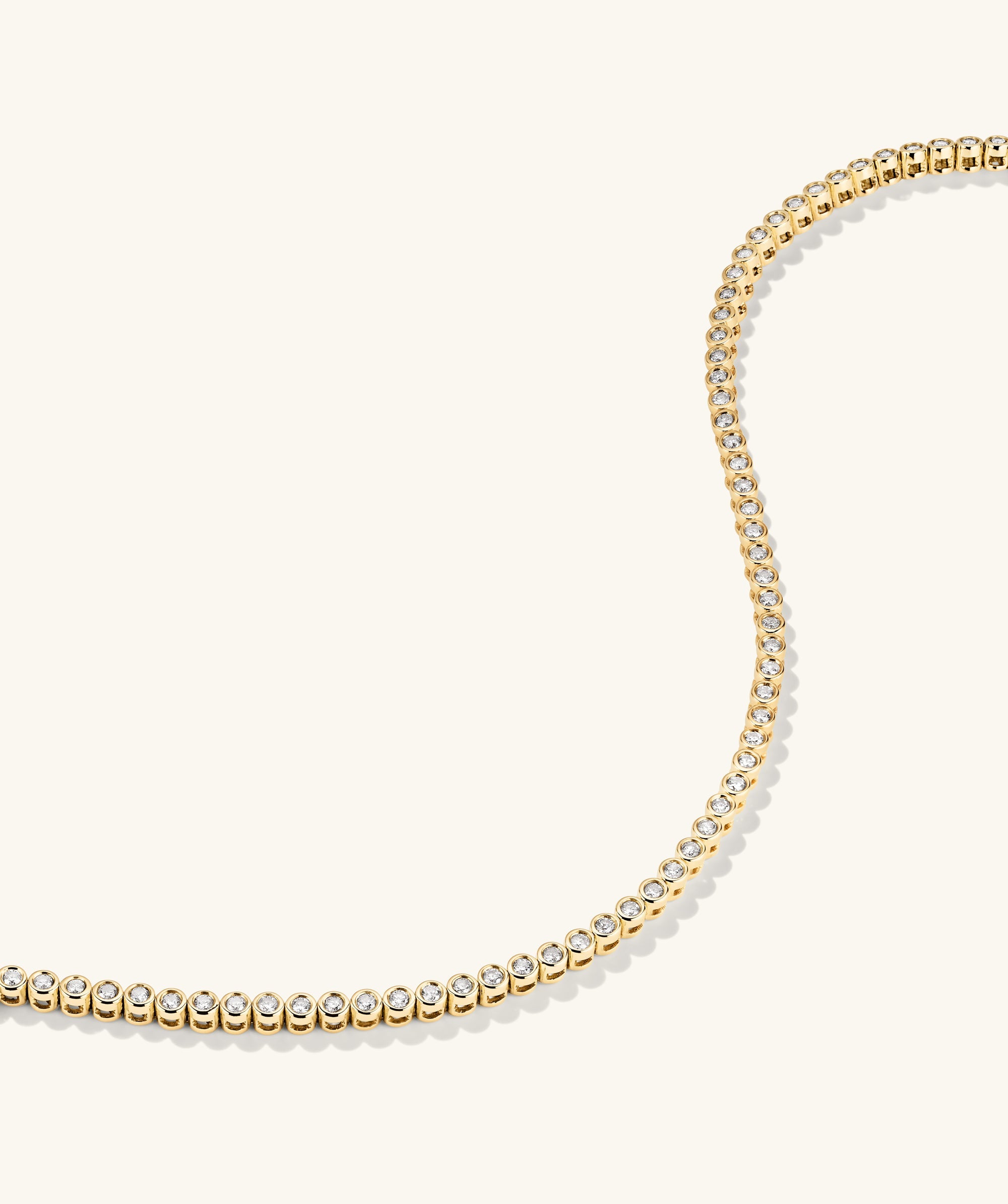 Bezel Lab Grown Diamond Tennis Bracelet: A handcrafted 14k gold bracelet featuring bezel-set, lab-grown diamonds, offering a sparkling, ethical alternative to natural diamonds.