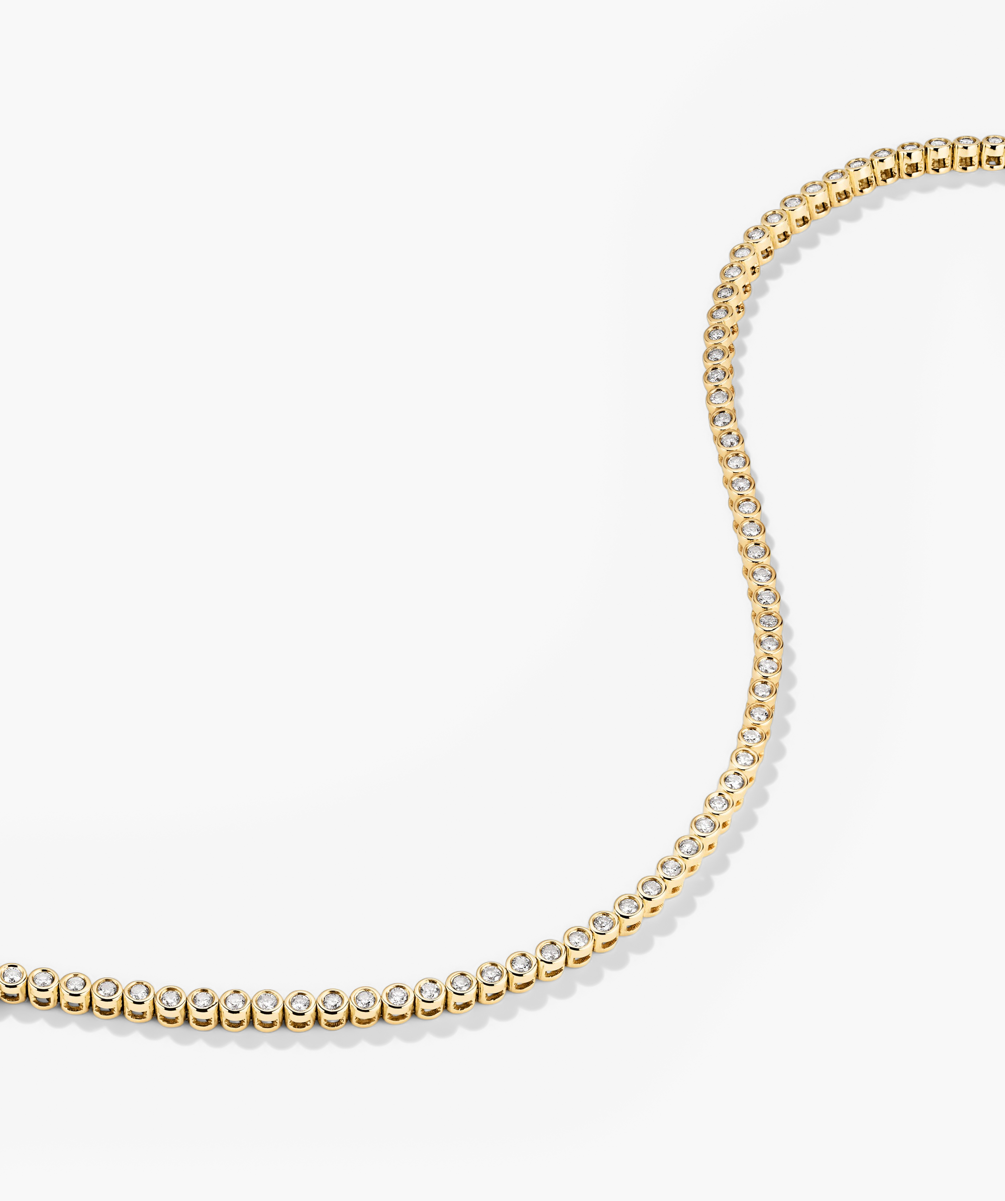 Bezel Lab Grown Diamond Tennis Bracelet: A handcrafted 14k gold bracelet featuring bezel-set, lab-grown diamonds, offering a sparkling, ethical alternative to natural diamonds.