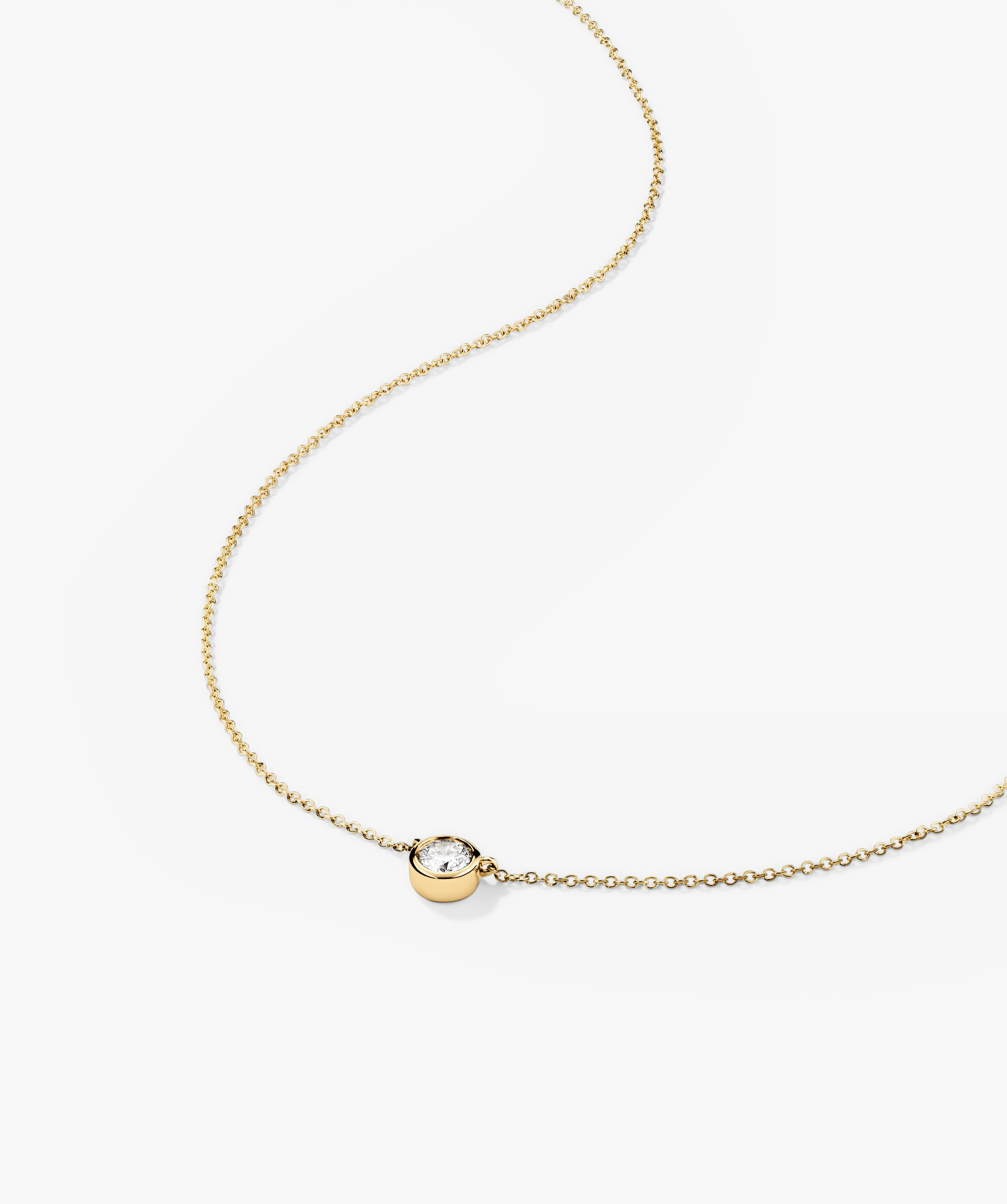 Bezel Lab Grown Diamond Necklace: A 14k solid gold necklace with a central bezel-set lab grown diamond pendant.