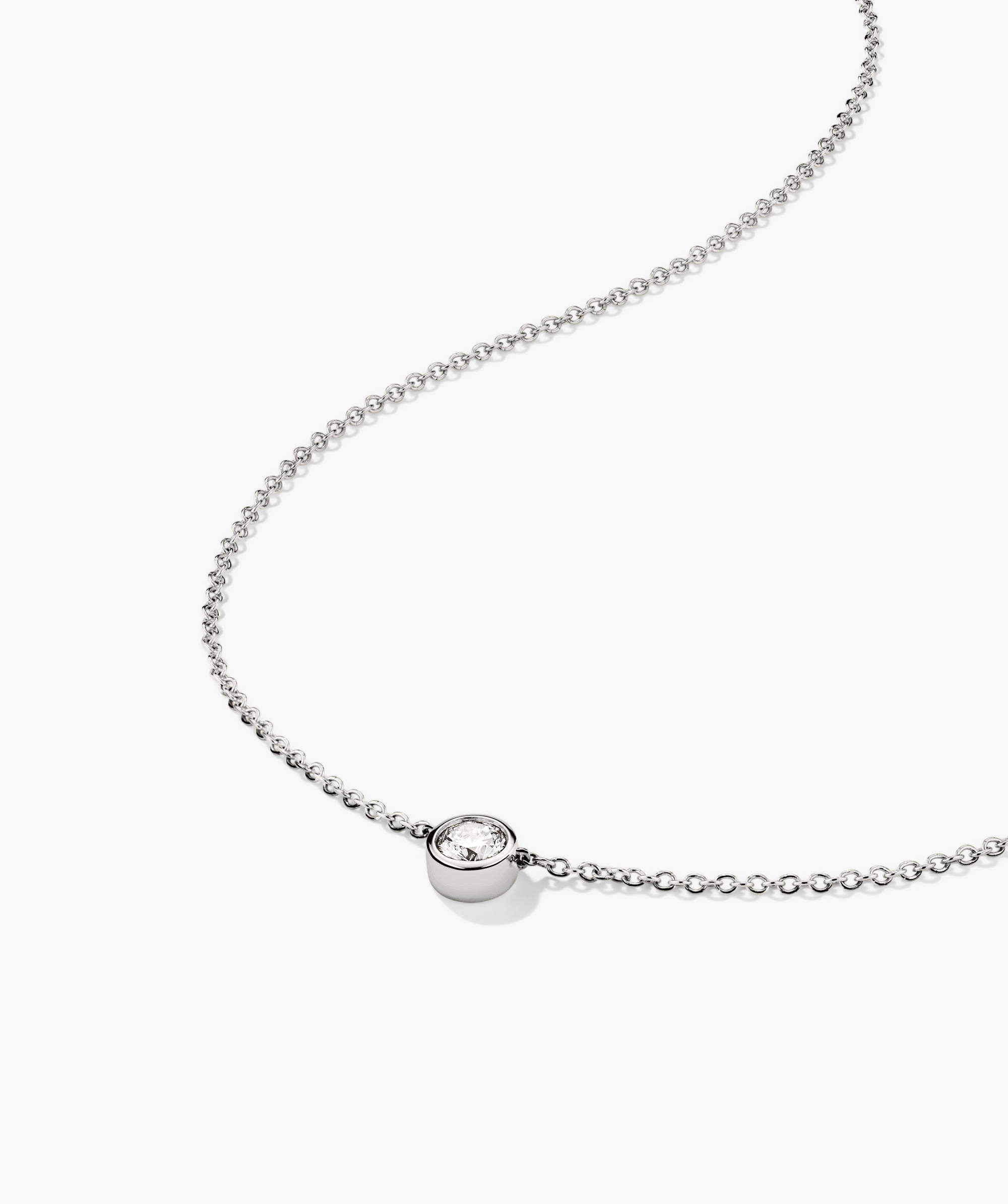 Bezel Lab Grown Diamond Necklace: A 14k solid gold chain with a bezel-set, lab grown diamond pendant, showcasing a sparkling, ethical and responsibly produced gem.