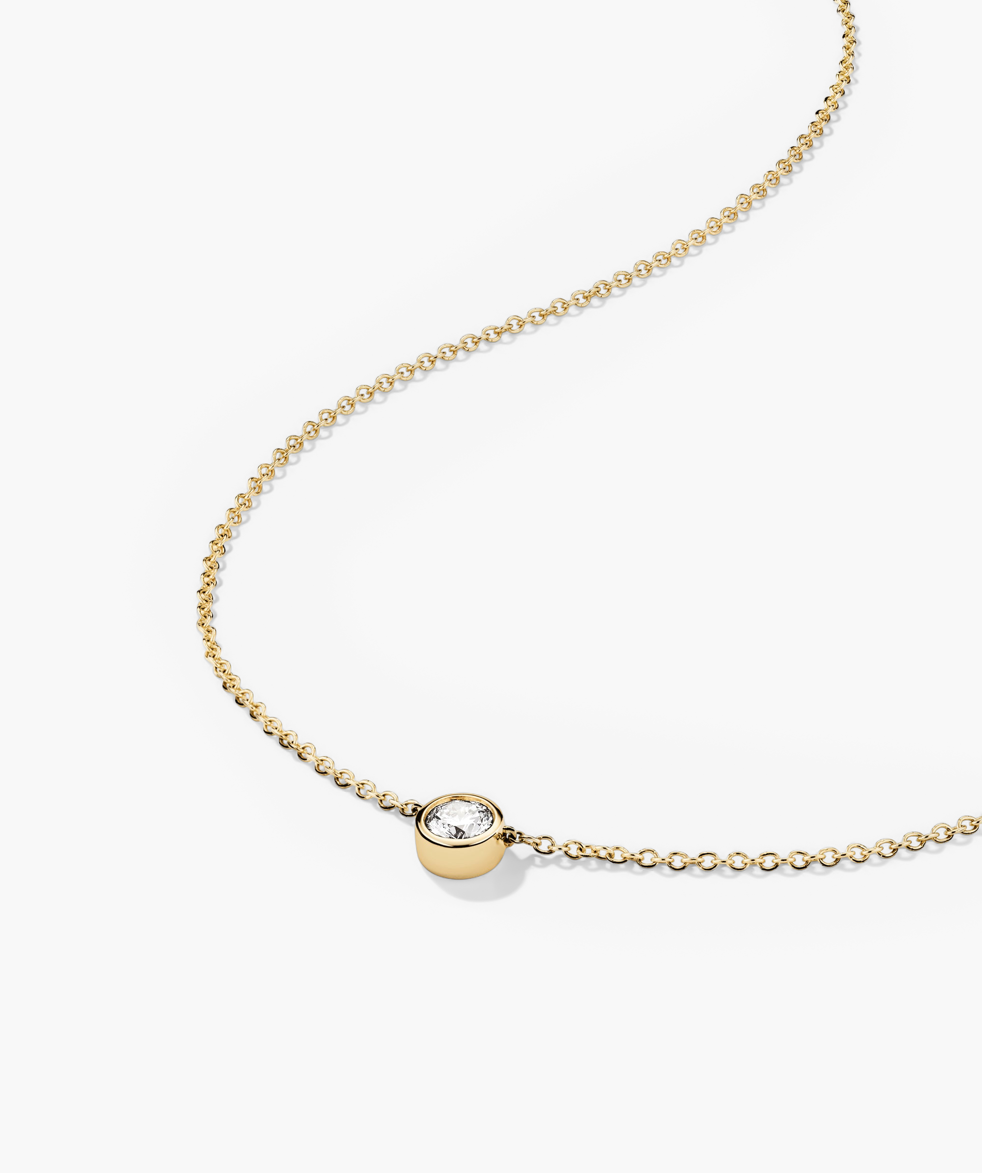 Bezel Lab Grown Diamond Necklace featuring a gold chain with a bezel-set lab grown diamond pendant, showcasing a blend of elegance and ethical craftsmanship.
