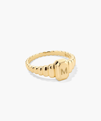 Charlotte Step Cut Signet Ring featuring a letter engraving on gold, designed as an engravable statement accessory enhancing any outfit with its textured elegance.