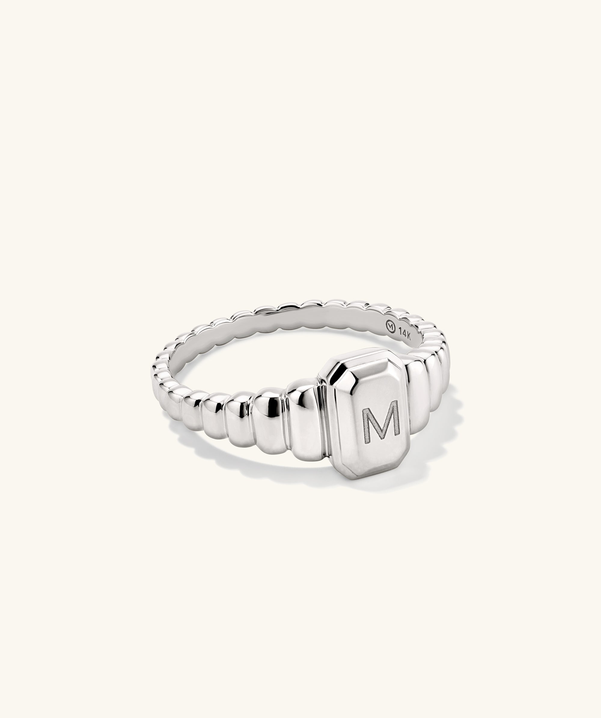 Charlotte Step Cut Signet Ring featuring a silver finish with an engravable letter, offering a textured design ideal for making a fashion statement.
