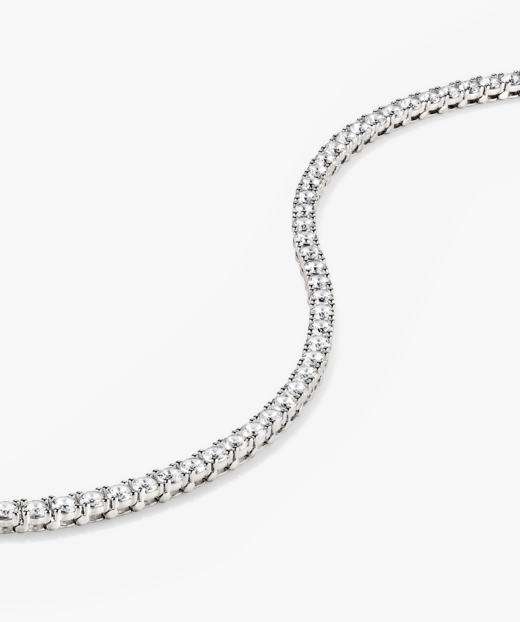 Lab Grown Sapphire Tennis Bracelet: Close-up of a sterling silver bracelet featuring lab-grown sapphires, showcasing its intricate design and sparkling gemstones.
