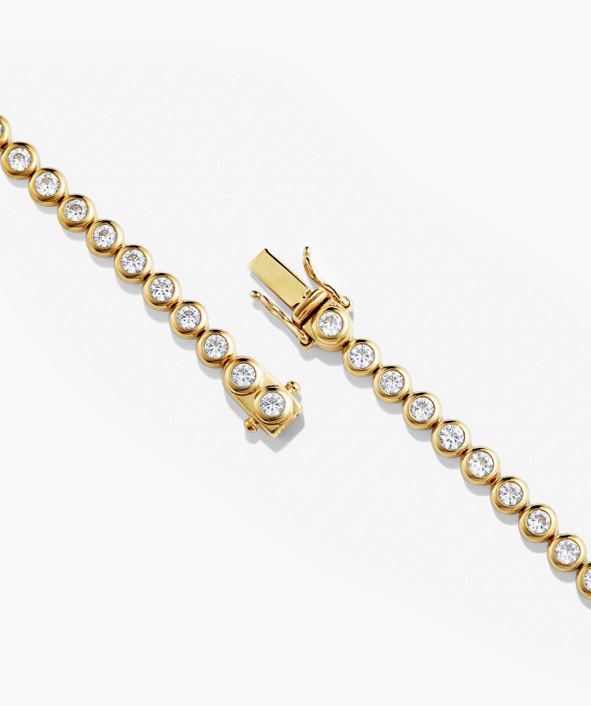 Zadie Bezel Lab Grown Sapphire Tennis Bracelet, featuring shimmering diamonds in a gold bracelet, showcasing a close-up of intricate bezel settings for enhanced brilliance.