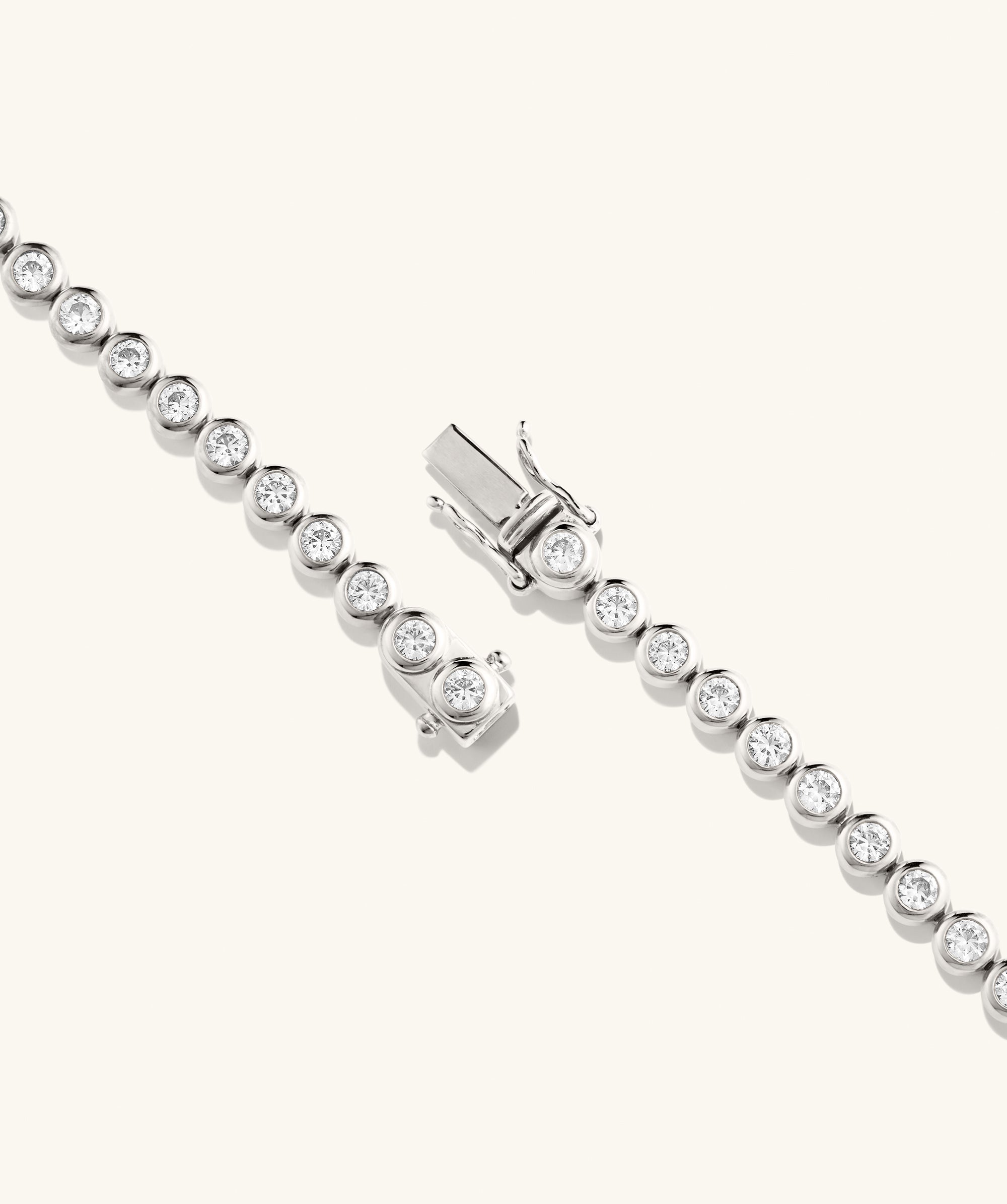 Zadie Bezel Lab Grown Sapphire Tennis Necklace featuring a silver chain adorned with sparkling lab-grown sapphires in a bezel setting, showcasing luxury and elegance.