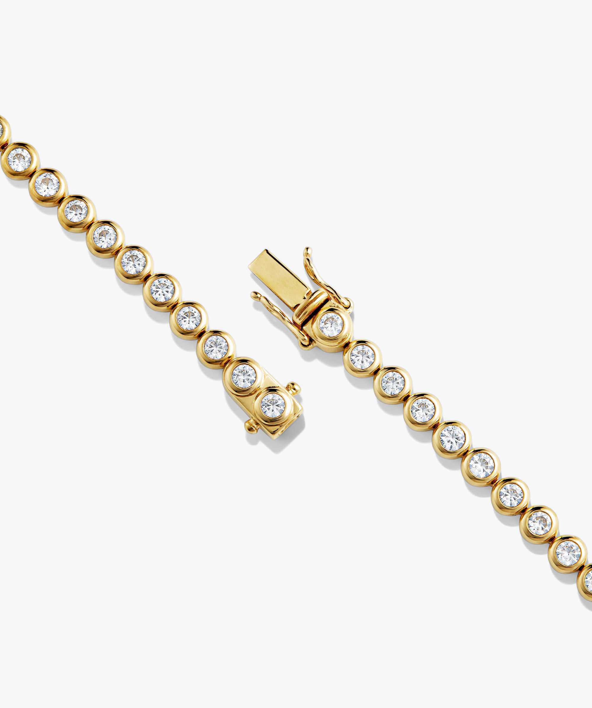 Zadie Bezel Lab Grown Sapphire Tennis Necklace featuring a gold bracelet design with diamond-like details, emphasizing its shimmering appeal and fashion-forward elegance.