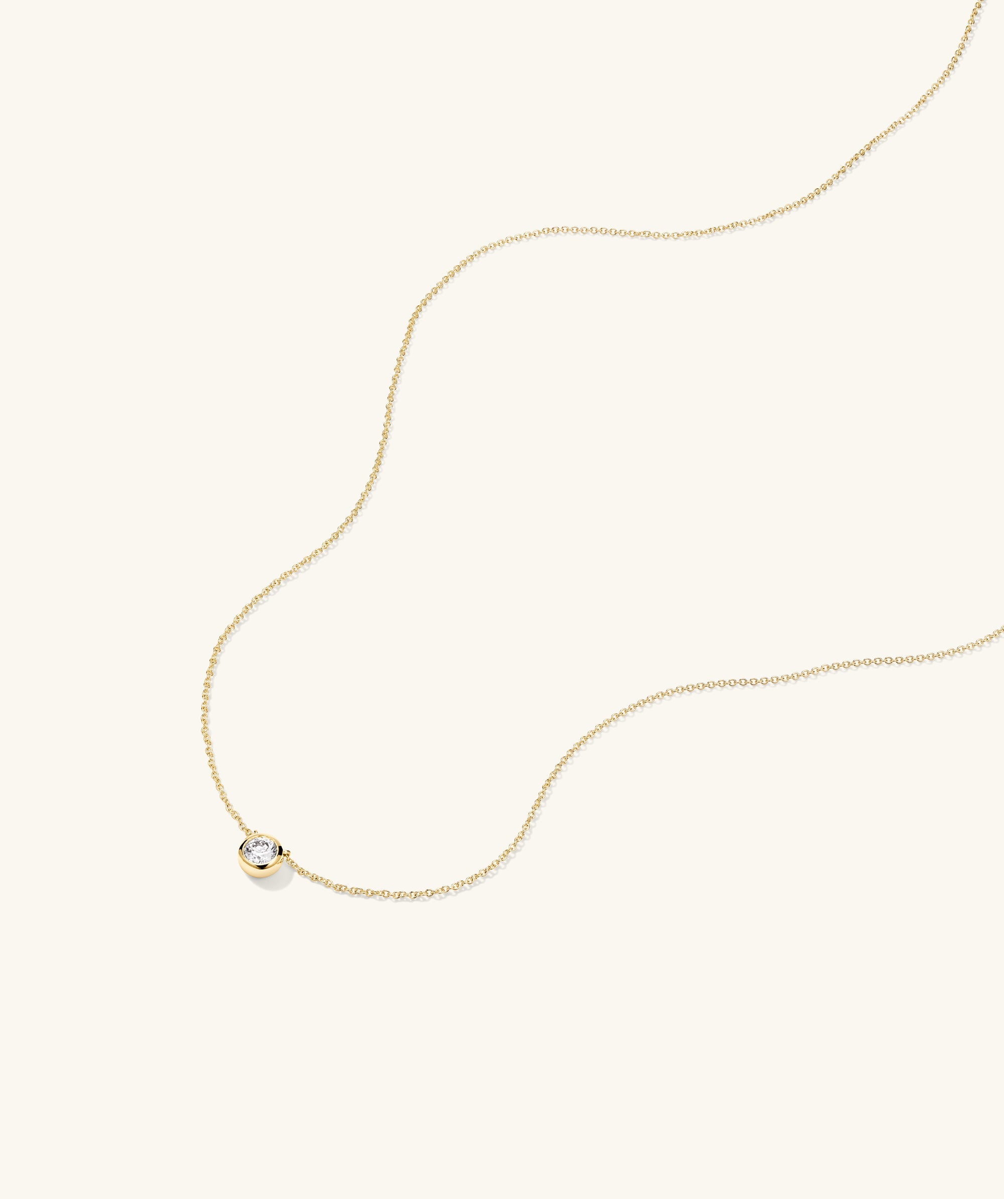 Large Diamond Necklace: A gold chain featuring a prominent diamond pendant, crafted as a timeless heirloom piece.