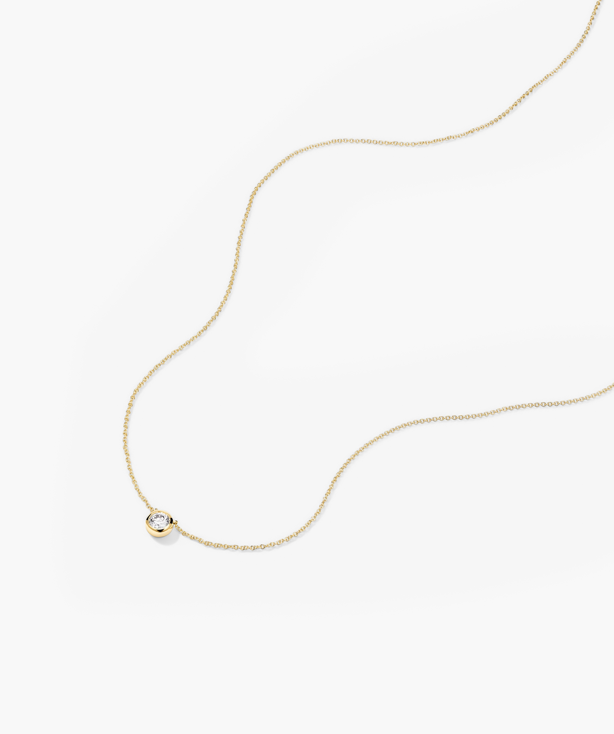 Large Diamond Necklace: A gold chain featuring a prominent diamond pendant, crafted as a timeless heirloom piece.