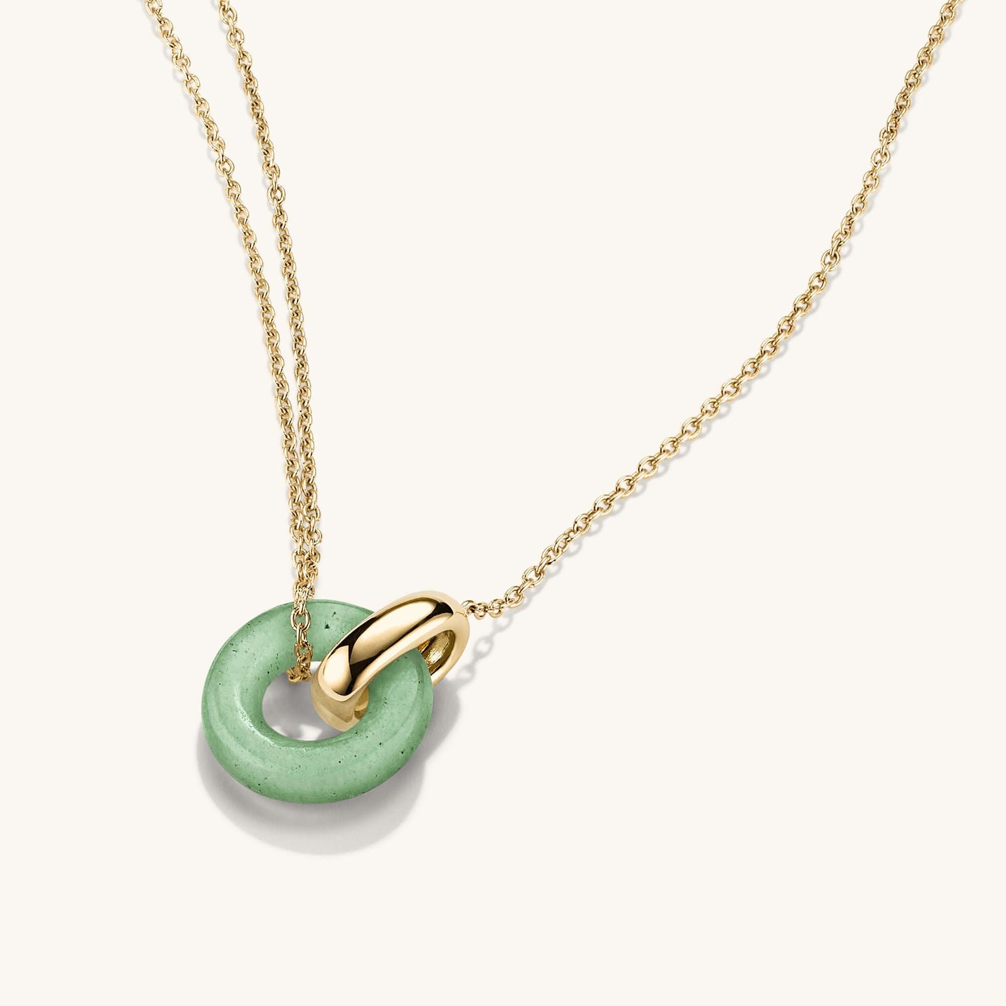 Linked Gemstone Necklace featuring a gold chain with a green aventurine pendant, showcasing two interlinked rings symbolizing personal bonds.
