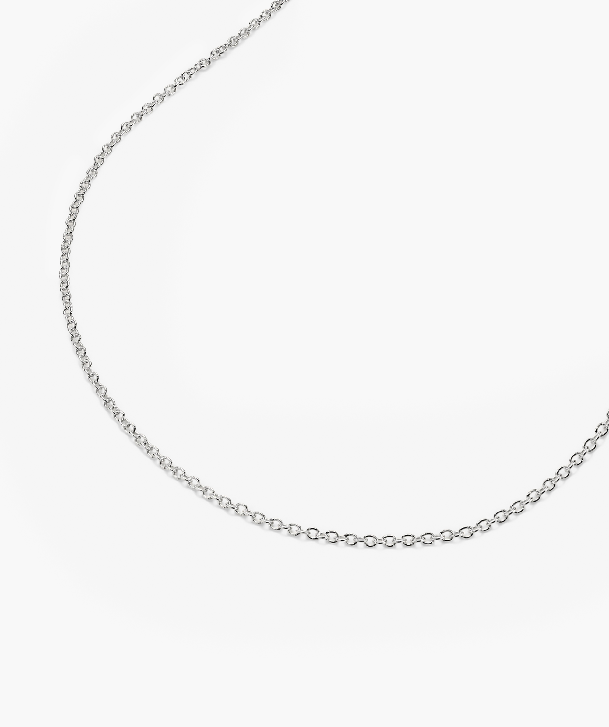 Cable Chain Necklace: A silver chain with a simple, timeless design, perfect for any season, showcased on a plain white background.