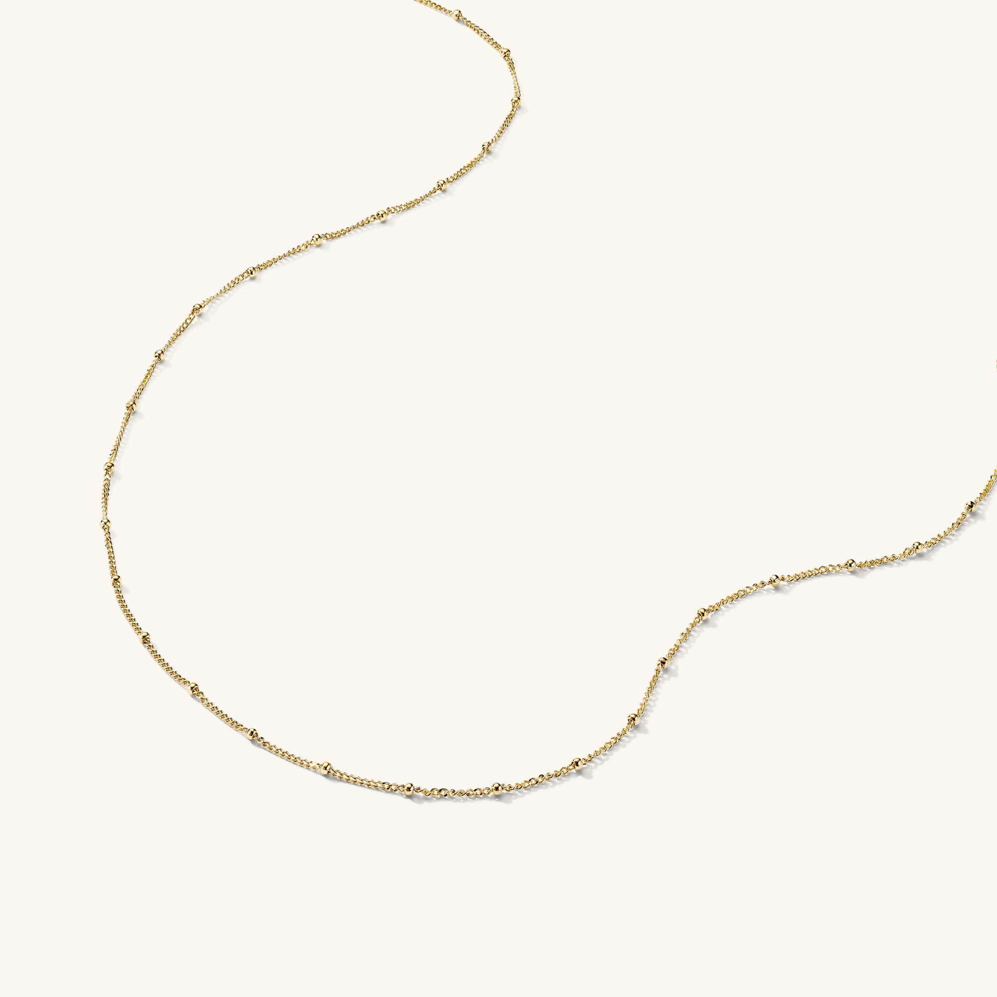 Spheres Chain Necklace: Minimal gold chain with spherical beads, versatile for any occasion.