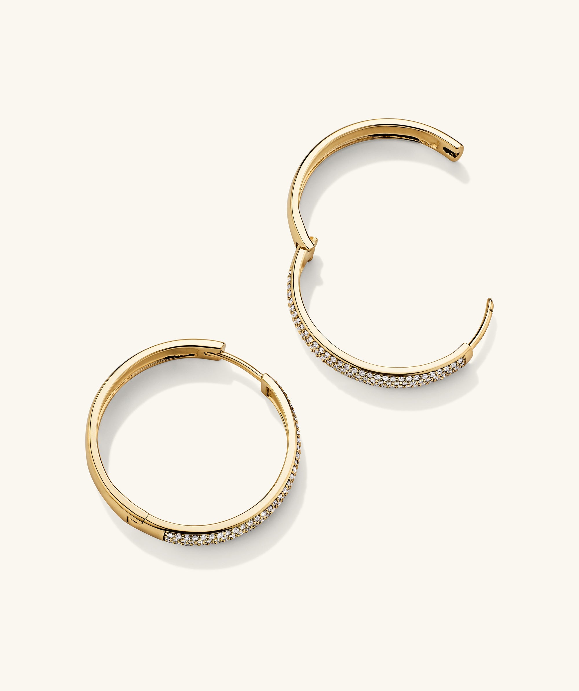 Bold PavÃ© Diamond Large Hoops: a pair of 14k solid gold hoop earrings adorned with responsibly sourced diamonds, designed to sparkle and attract compliments.