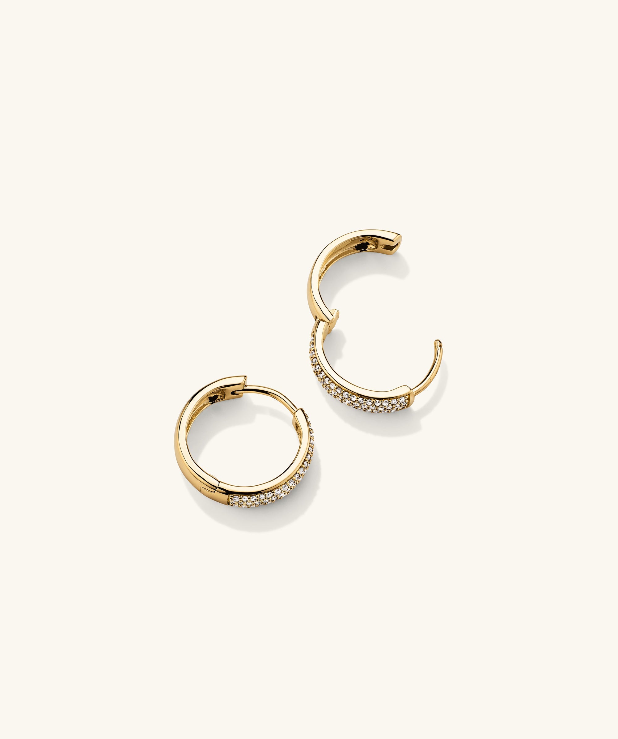Bold PavÃ© Diamond Small Hoops: A pair of handcrafted 14k gold hoop earrings adorned with responsibly sourced diamonds.
