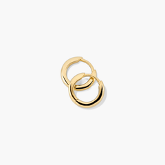 Tube Huggie Hoops: A pair of modern gold hoop earrings with a clicker closure, designed to be bold yet lightweight for comfortable wear.