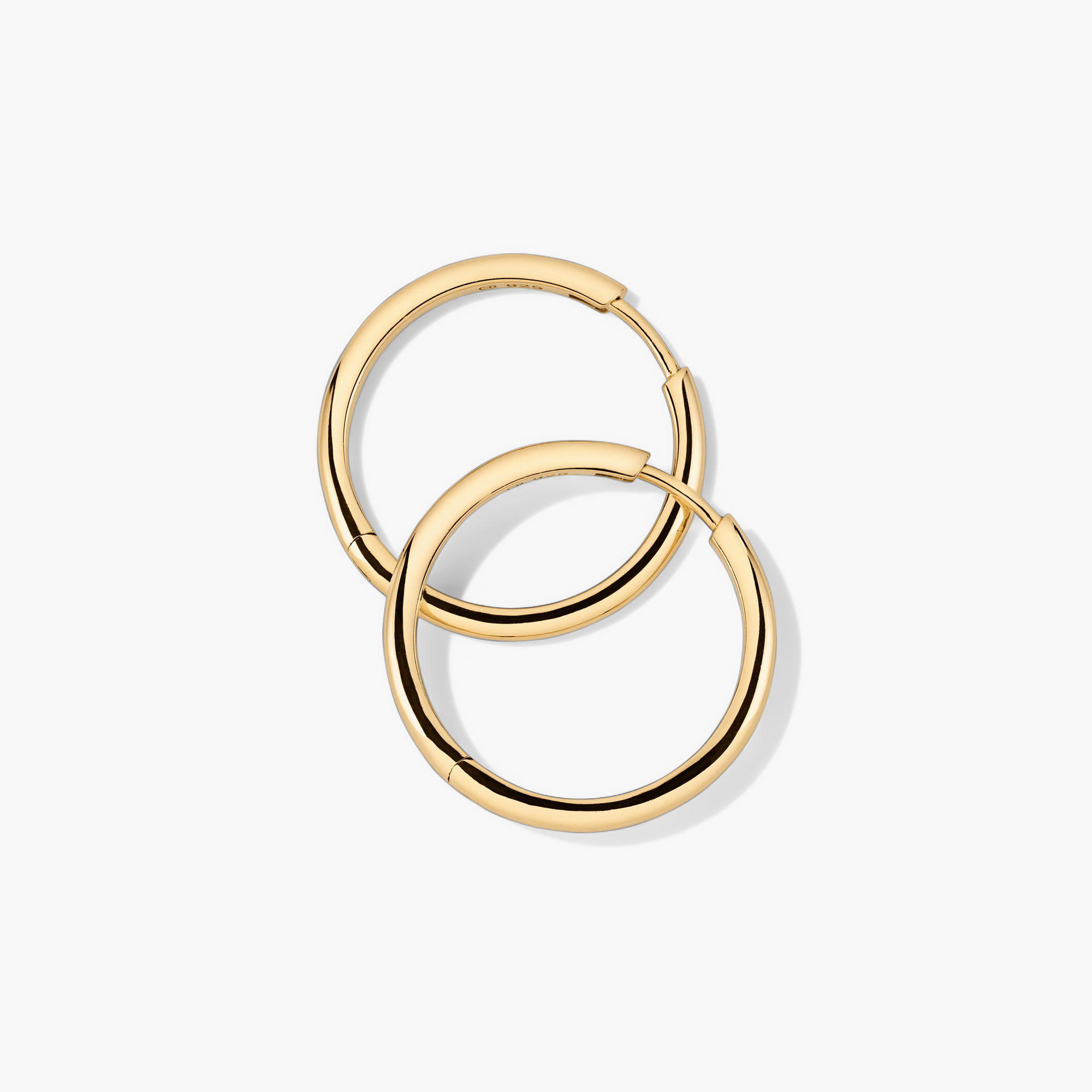 Tube Large Hoops: Lightweight gold hoop earrings with a clicker closure, designed for modern comfort and effortless wear.