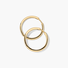 Tube Large Hoops: Lightweight gold hoop earrings with a clicker closure, designed for modern comfort and effortless wear.