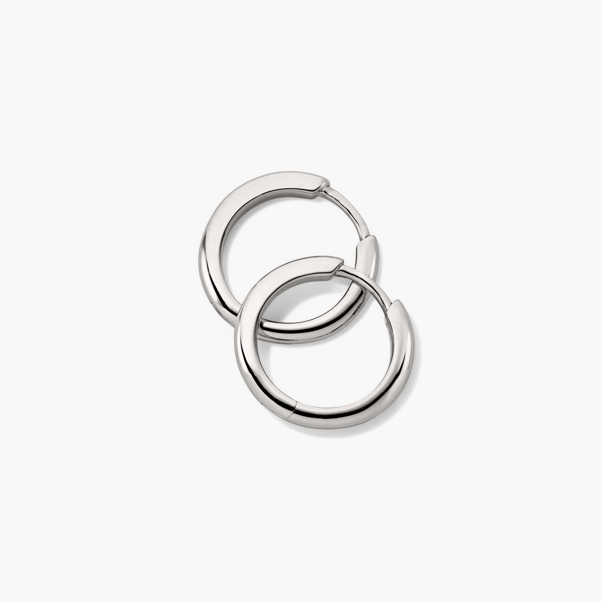 Tube Medium Hoops: A pair of silver hoop earrings with a modern tube design, featuring a lightweight build and clicker closure for comfort and security.