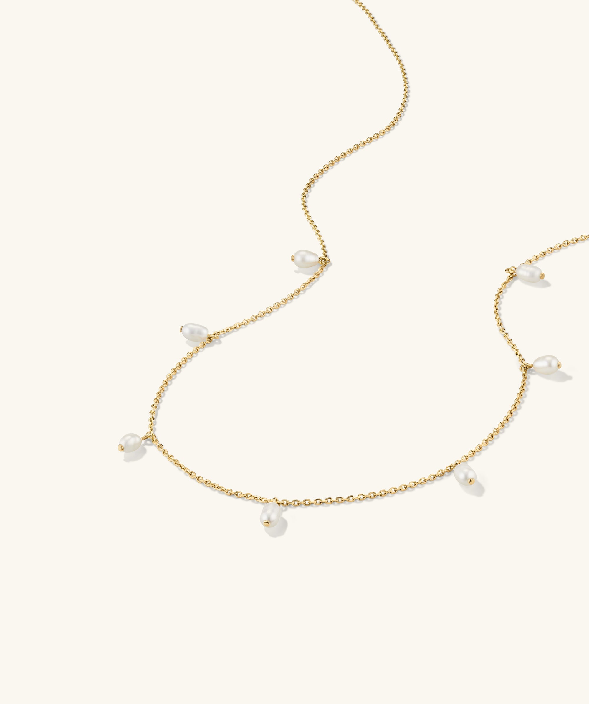 Tiny Pearl Station Necklace: An 18k gold vermeil chain adorned with spaced freshwater pearls, finely handcrafted to accentuate minimalist elegance.